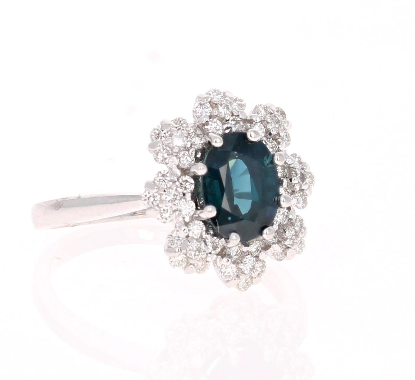 Beautiful Blue Sapphire and Diamond Ring!  This ring has an Oval Cut Sapphire set in the center of the ring that weighs 1.82 Carats. It has 48 Round Cut Diamonds that weigh 0.50 carats set in a petal like design surrounding the Sapphire.  The