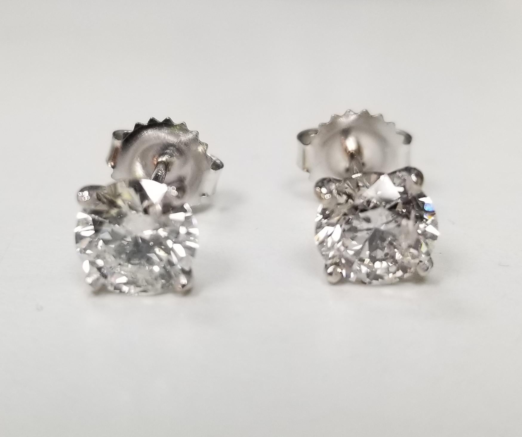 Diamond stud earrings , containing 2 brilliant cut diamonds; color 