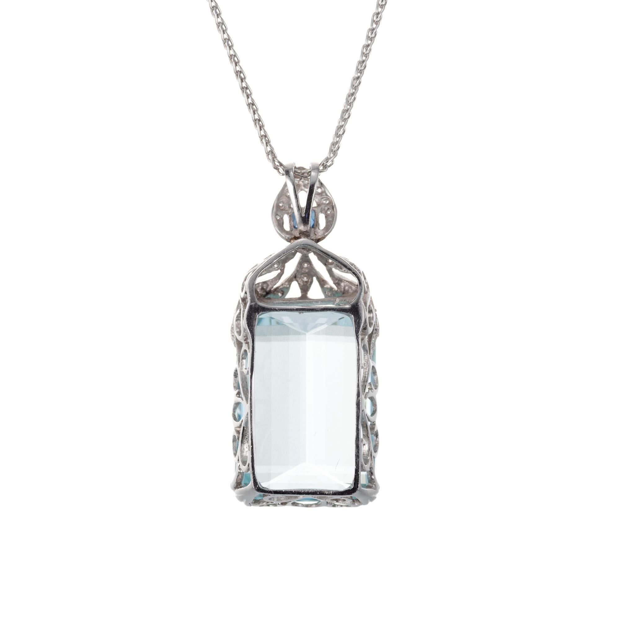Original natural light slightly greenish blue aquamarine. Scroll setting with a French cut sapphire and 28 accent diamonds, set in platinum. 

1 natural untreated emerald cut 23.20ct aquamarine
1 French cut genuine sapphire .15cts.
28 diamonds
