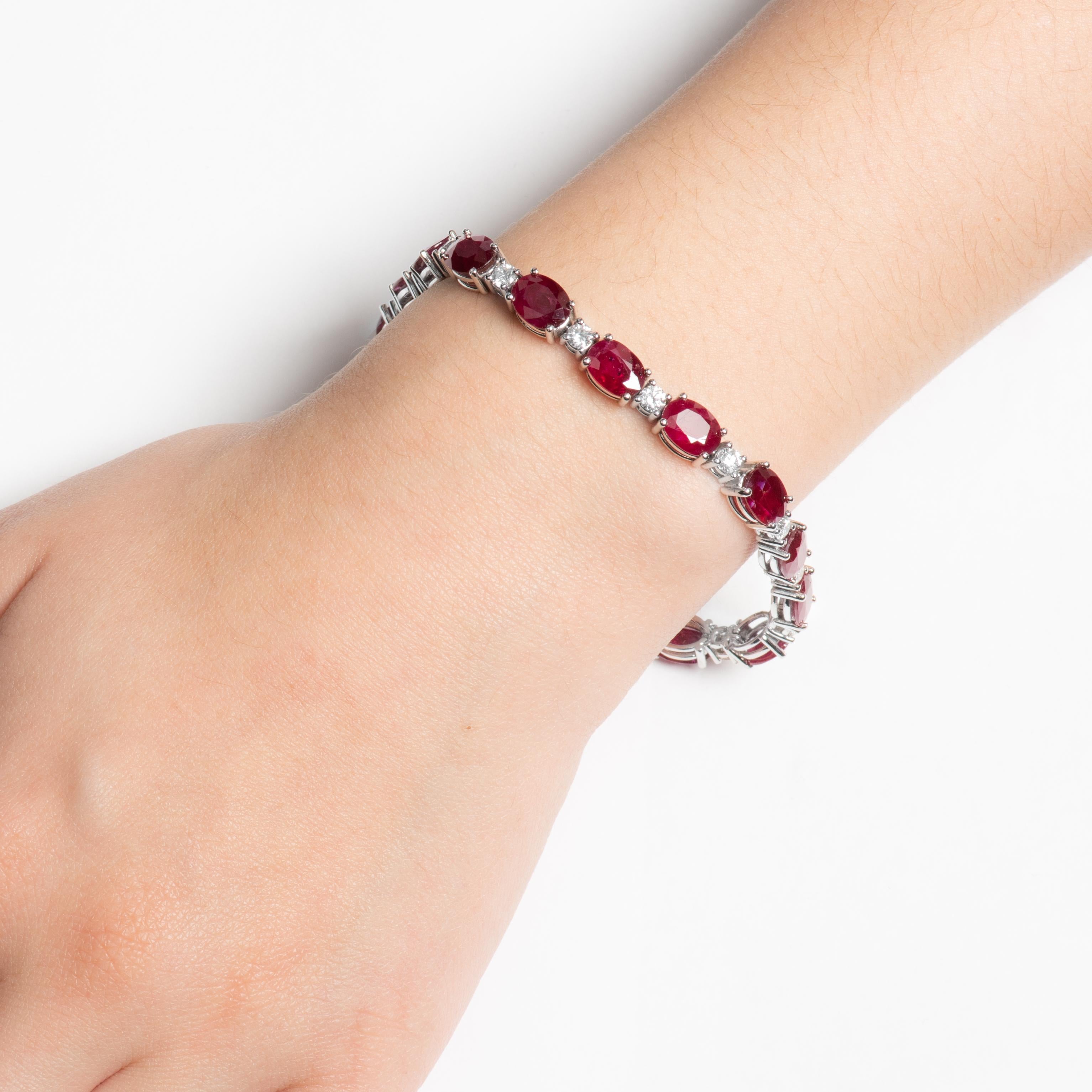 This stunning bracelet has a series of 23.27ct total weight in oval shaped rubies, with 2.04ct total weight in round diamond bordering each ruby. These precious gems are all set in a 14kt white gold, 7 inch bracelet.
Diamond quality: F-G color,