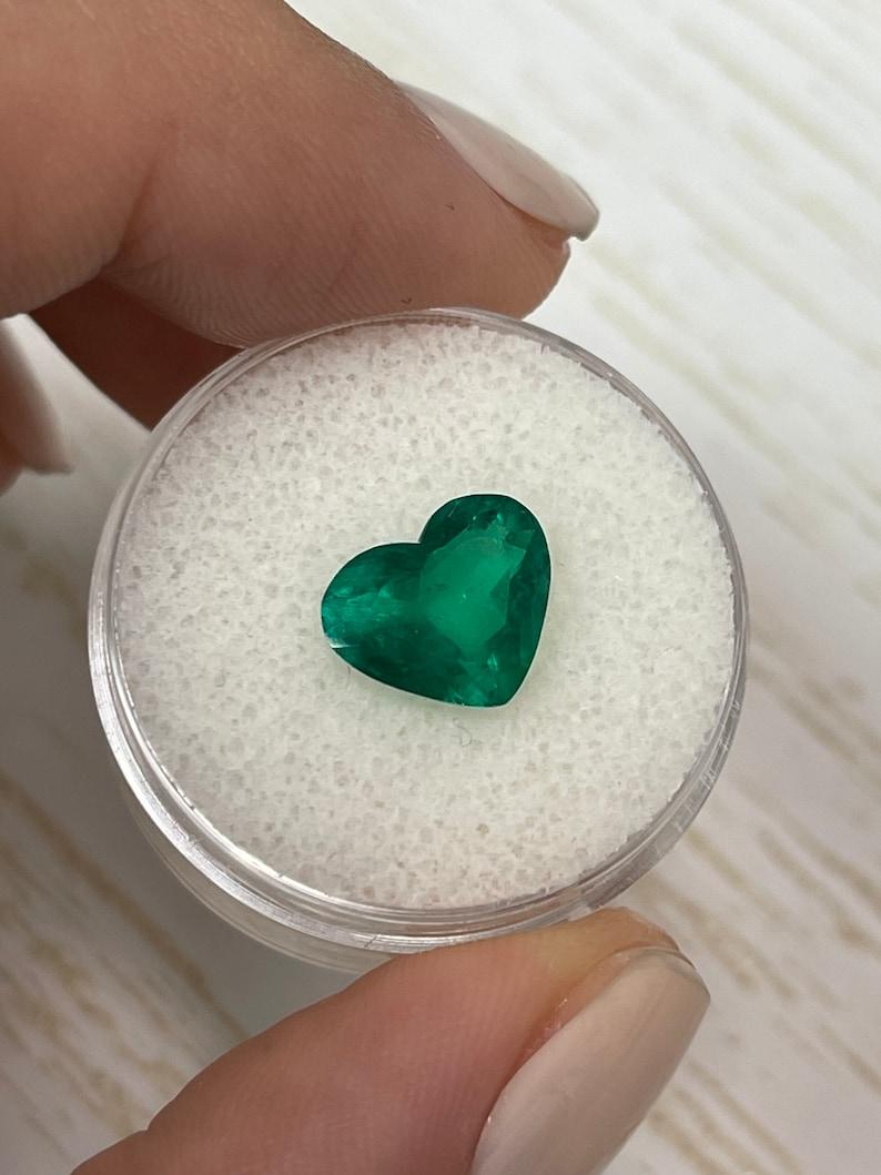 Stone: Emerald
Weight: 2.33-carats
Shape: Heart Cut
Clarity: Transparent
Luster: Excellent/Very Good
Color: Vivid Dark Muzo Green
Measurements: 10.76mm x 8.96mm x 4.92mm
Geographic Origin: Colombia
Treatment: Natural, Moderate Oil

Comments: Due to