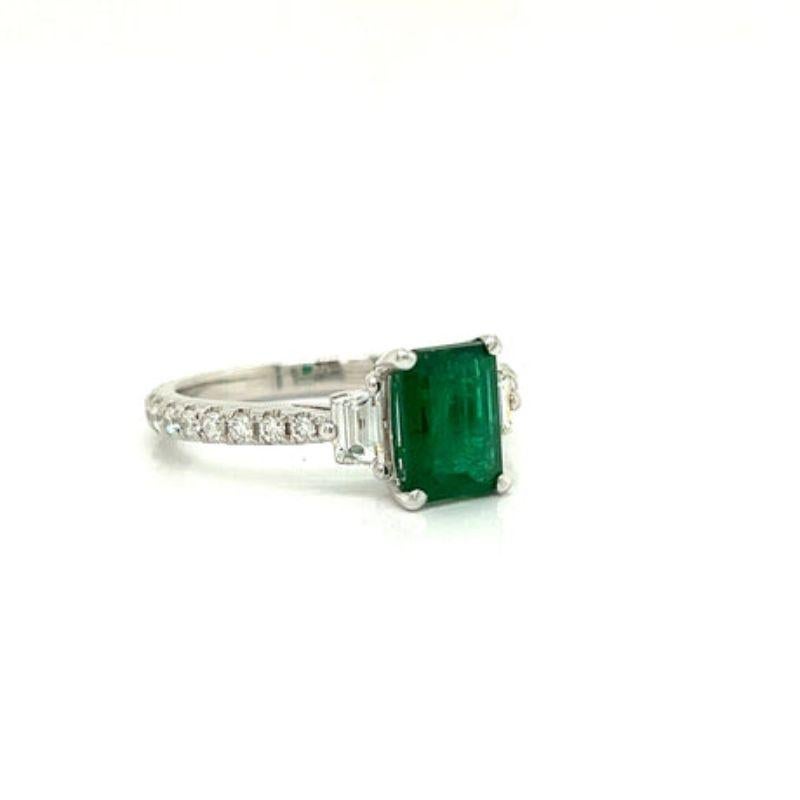 This stunning Emerald and Diamond Platinum Ring is truly eye-catching and will turn heads with its captivating sparkle. The 2.33 carat emerald center is surrounded by .52 ctw of brilliant round diamonds with two tapered baguettes for an additional