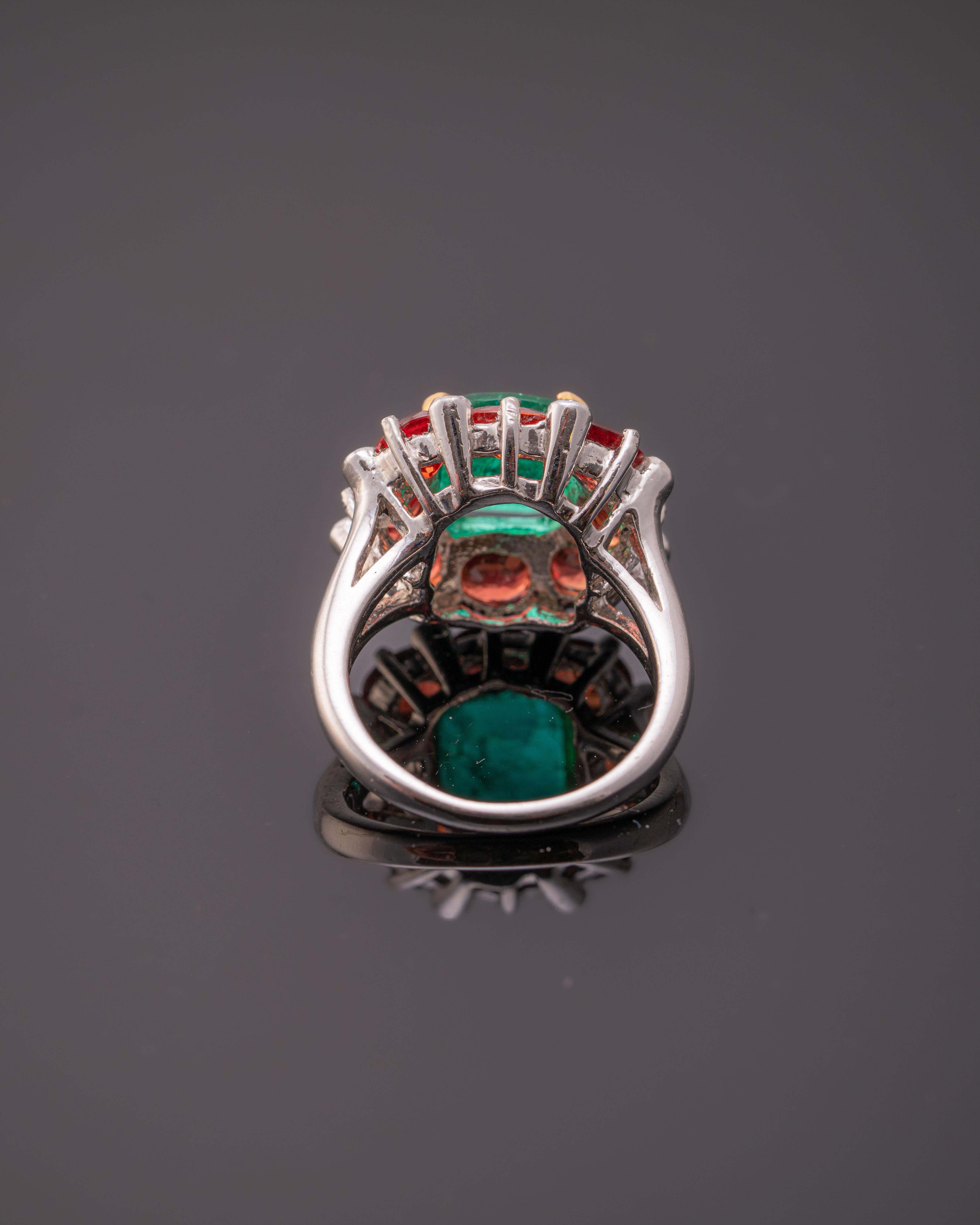 A beautiful combination of cushion shaped 2.33 carat Zambian Emerald and vivid 3.63 carat of oval Orange Sapphires, set with 0.14 carat White Diamonds in Platinum. The centre stone Emerald and sorrounding Orange Sapphire is absolutely transparent,