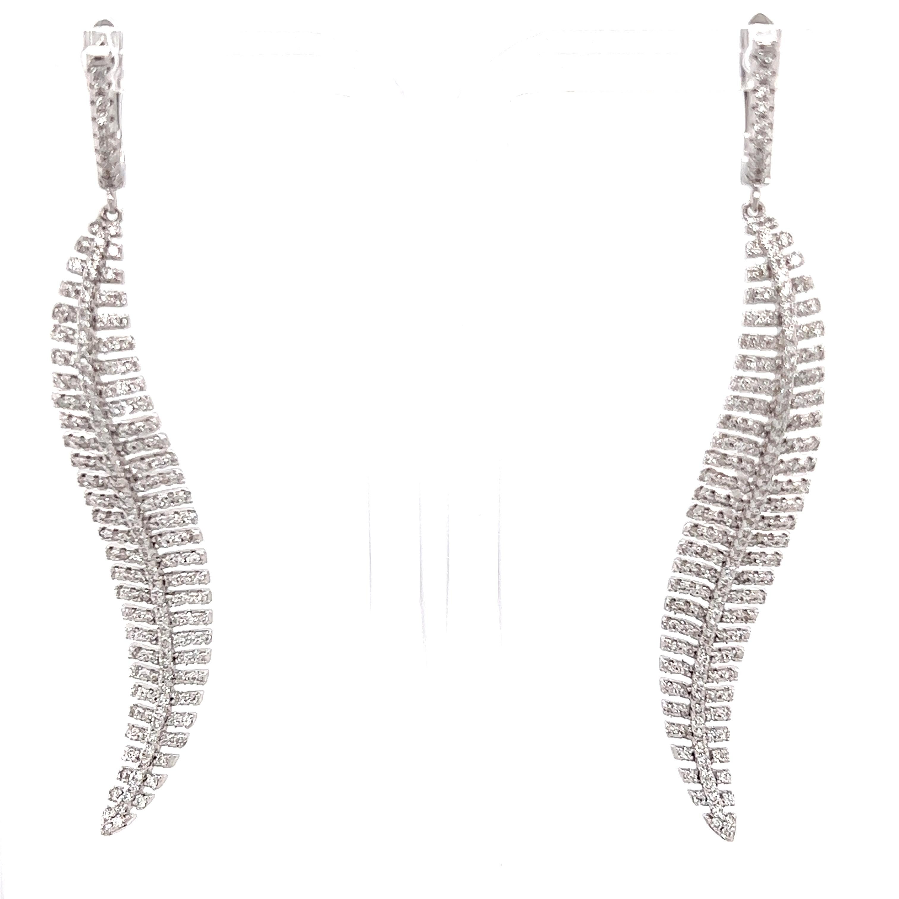 These earrings have Natural Round Cut White Diamonds that weigh 2.33 carats. The clarity and color of the earrings are VS-F. 

They are 2.75 inches long and are curated in 14 Karat White Gold with an approximate weight of 12.9 grams. 

Stunning