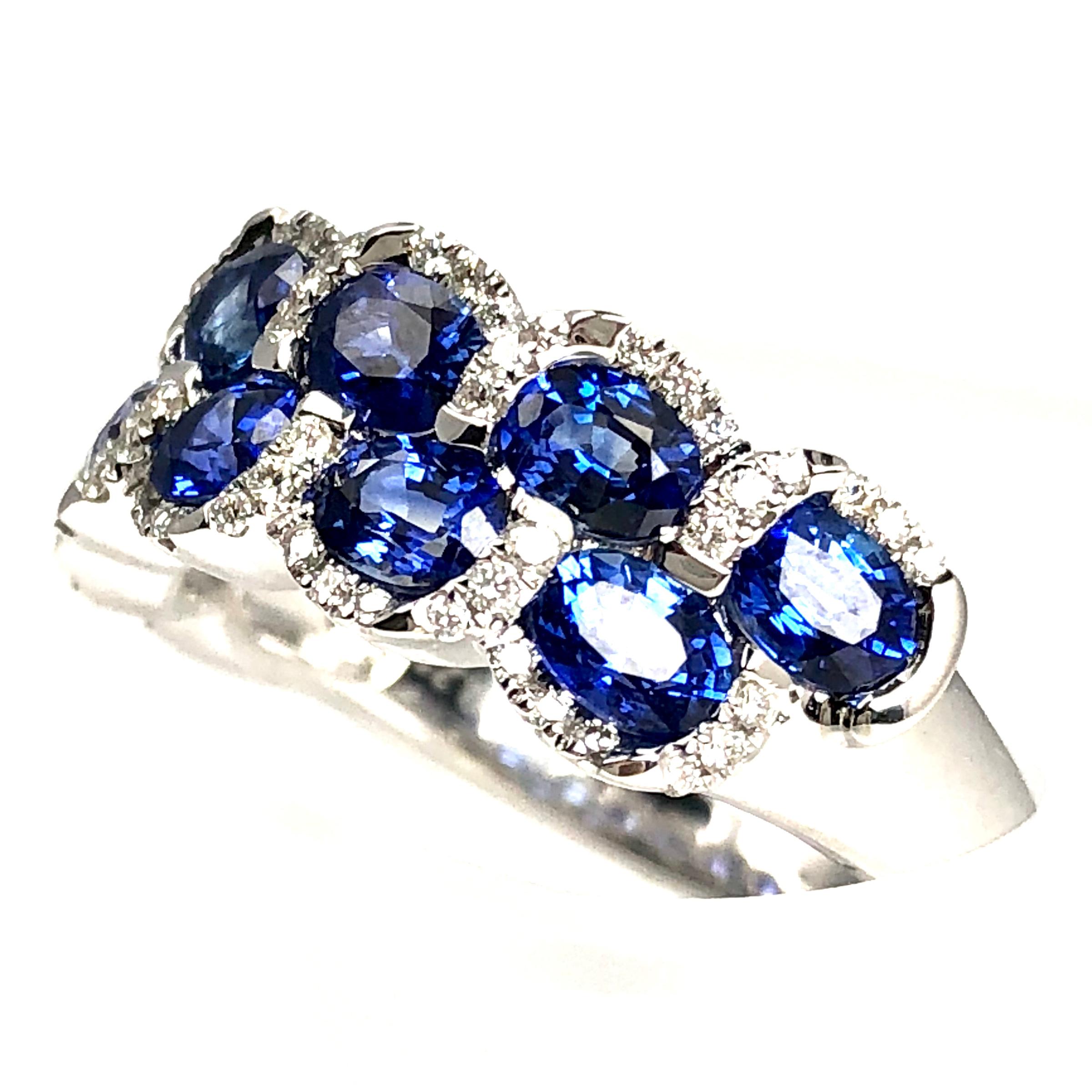 This ring has 11 oval cut blue sapphires totaling 2.33 carats, wrapped inside 66 round cut diamonds totaling 0.23 carats.

Set in 18k White Gold.

This ring is size 6.5, but can be professionally resized to your specification at no charge following