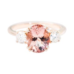 2.33 Carat Oval Morganite 0.53 Carat Diamond 18 Carat Gold Three Stone Ring