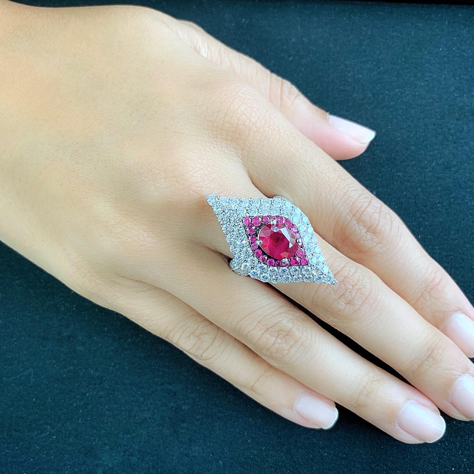 Butani's 18-karat white gold ring is encrusted with 3.3 carats of shimmering white diamonds, 0.58 carats of rubies and centered with an 2.33 carat oval-cut ruby.  Crafted in a sharp silhouette, the ring is size US 7.  For other sizes, please contact