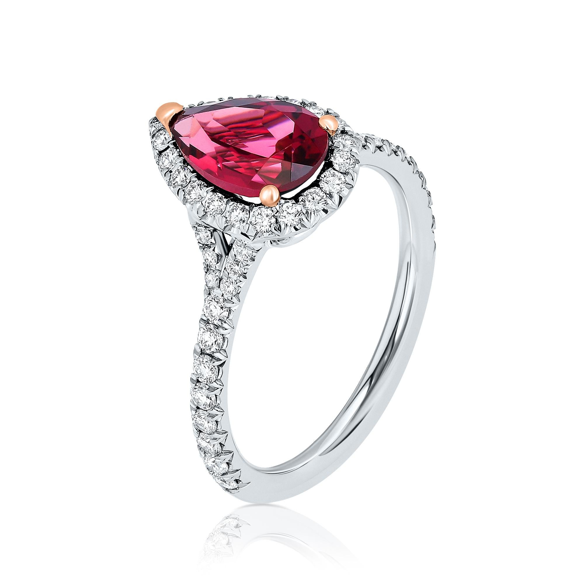 A stunning cocktail ring featuring a 1.86-carat pear-shaped Red Tourmaline (Rubellite) as its breathtaking centerpiece. Surrounding the vibrant center stone are sparkling round brilliant Diamonds, creating a halo effect that enhances its beauty.