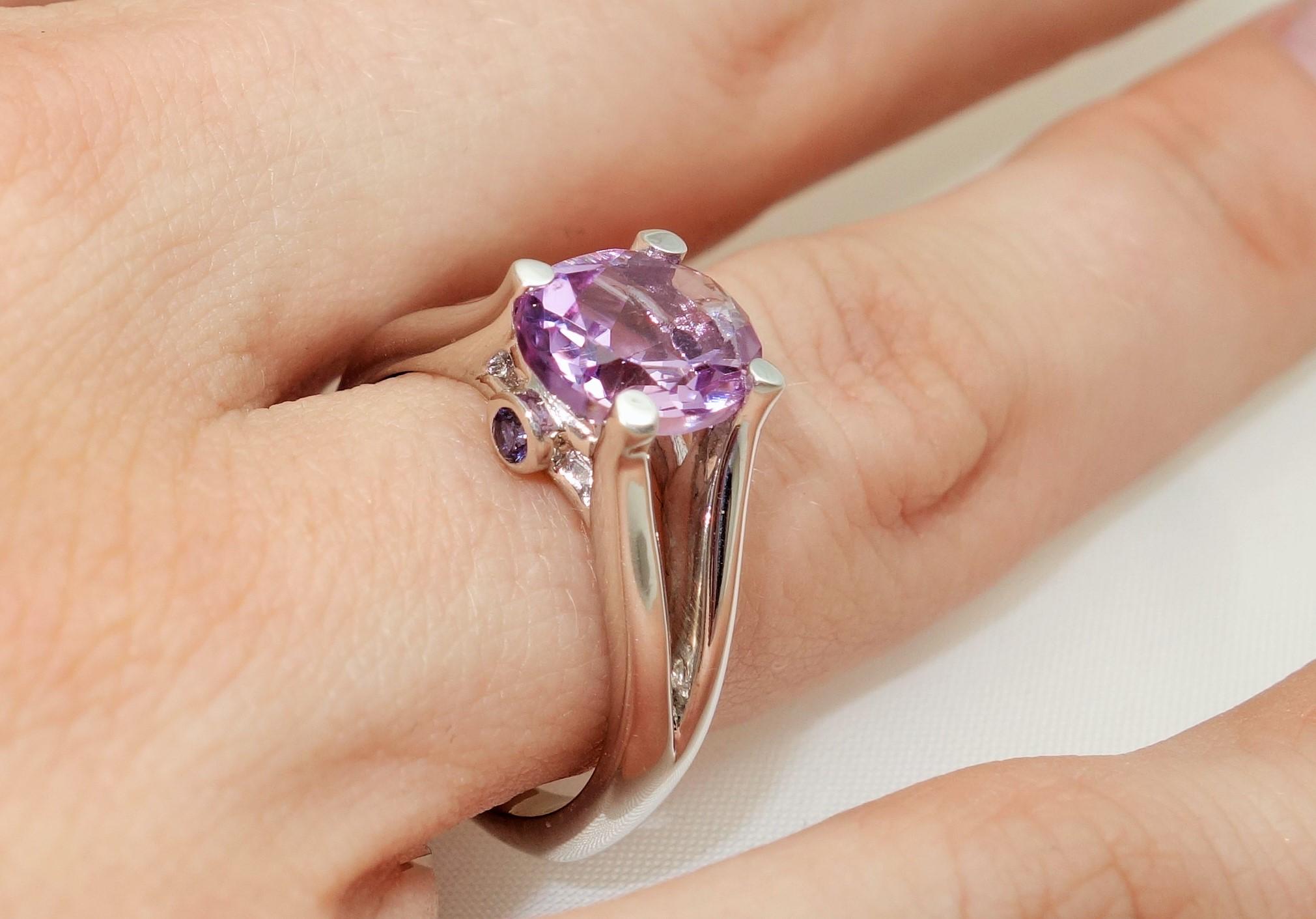 Beautiful ring featuring a 2.33 Carat Rose de France Amethyst in center enhanced with Sapphires; approx. 0.07 total carat weight; Sterling Silver Tarnish-resistant Rhodium mounting. Size 8, we offer ring re-sizing; Classic and Stylish…illuminating