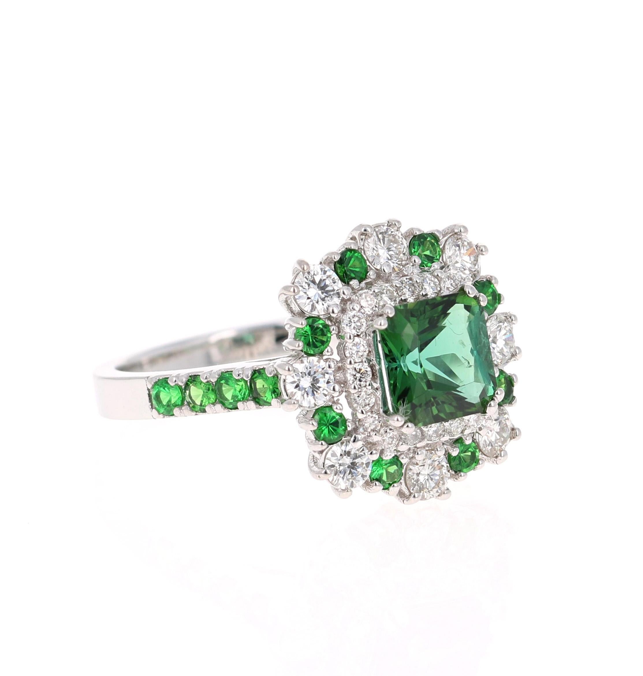 This gorgeous ring has a beautiful Square Cushion Cut Tsavorite weighing 1.36 carats and is surrounded by 27 Round Cut Diamonds weighing 0.70 carats and 8 Tsavorites that weigh 0.27 carats. The total carat weight is 2.33 carats.  

It is set in 18K