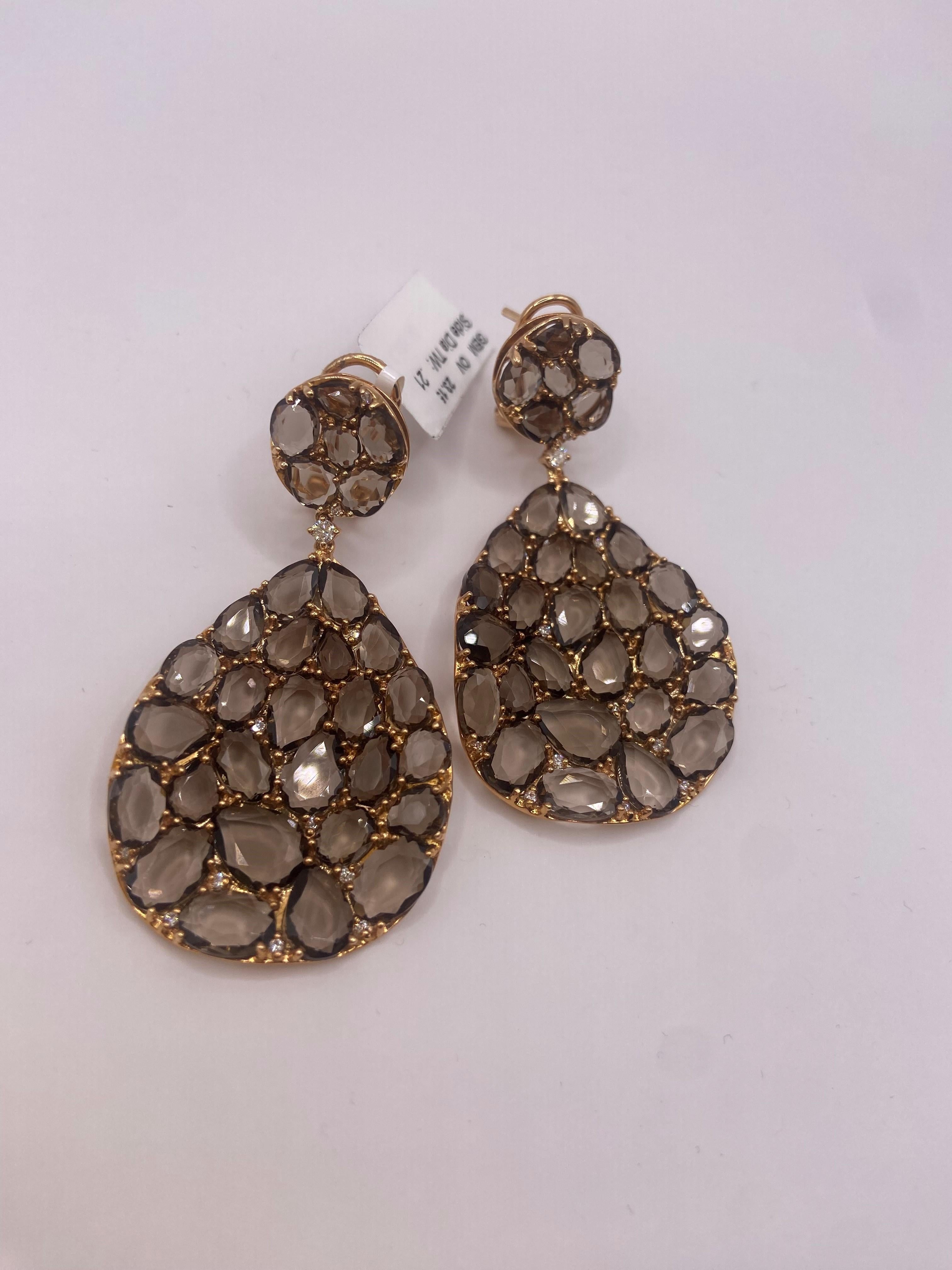•	18KT Rose Gold
•	23.36 Carats

•	24 Round Diamonds: 0.21ctw
•	Color: F
•	Clarity SI1

•	Number of Quartz: 62
•	Carat Weight: 23.15ctw

This pair of earrings is made with 62 rose cut brown quartz stones. The stones are set in 18KT rose gold and