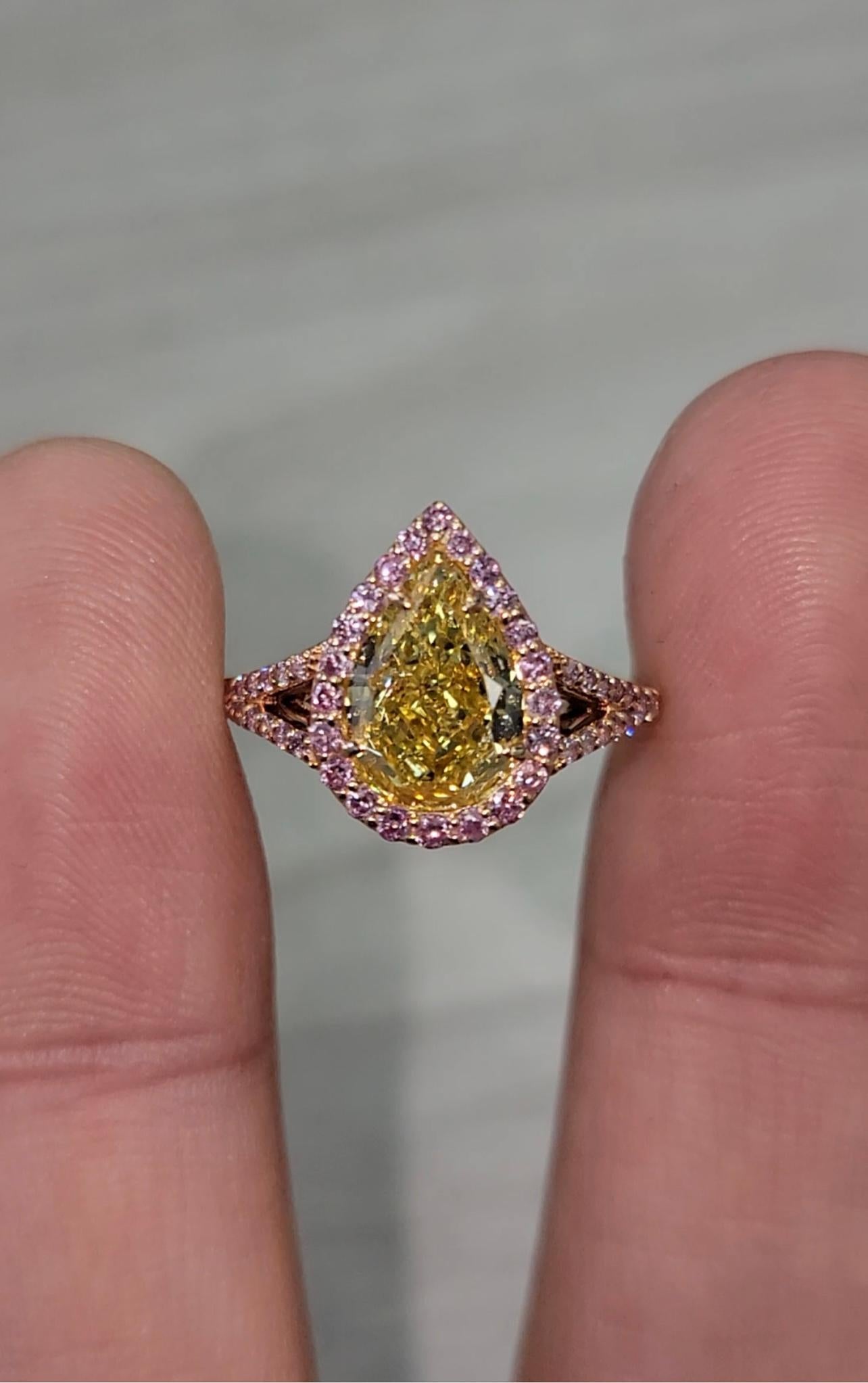 2.33ct GIA Pear Shape
I1 clarity (completely eye clean)
Very Saturated Color
Surrounded by fancy pink round diamonds weighing 0.47cts
Set in 18k rose gold