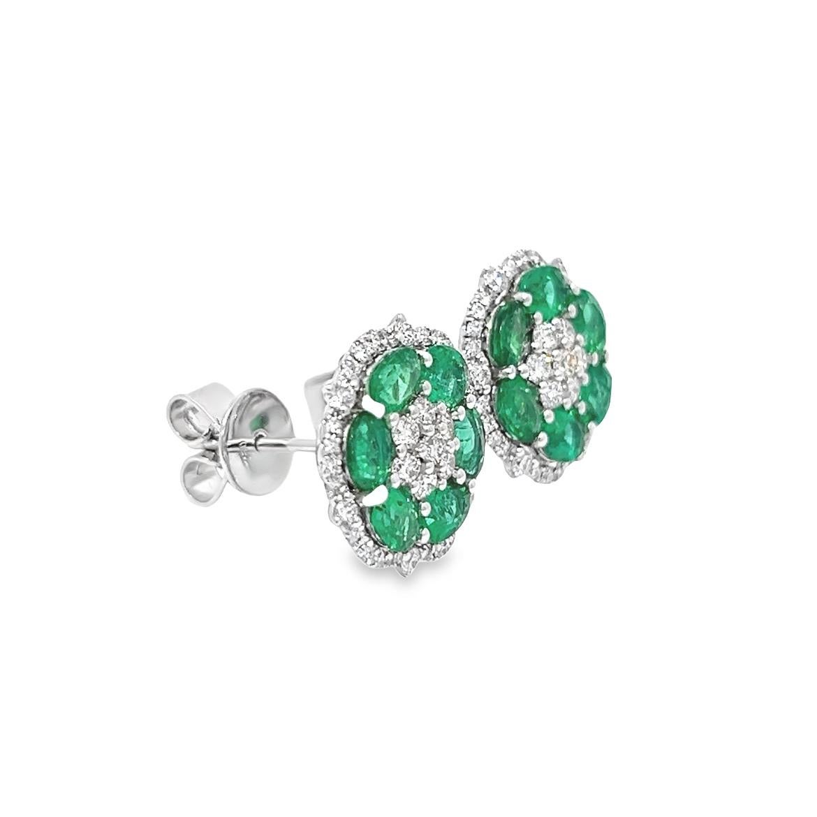 This beautiful pair of earrings are made of Natural Emeralds and a Good Quality of  Earthborn Diamonds summarizing the Emeralds beauty, set in polished 18K White Gold setting making this pieces an excellent accessory that can be used in a any