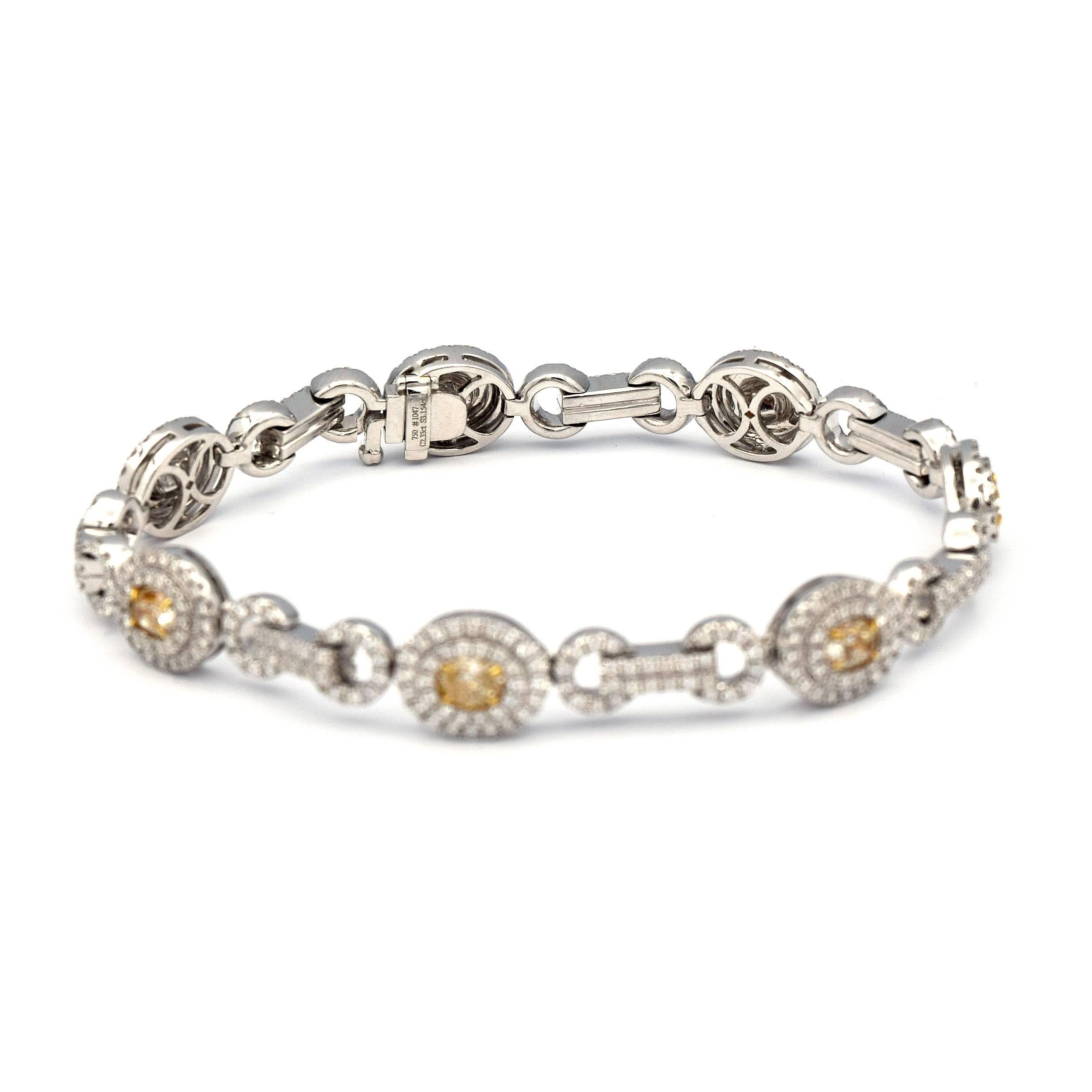 This Stunning and sophisticated bracelet has 7 beautiful Oval Shaped Fancy Light Yellow Diamonds, along with Pave White Diamonds, all giving a total caret weight of 2.33ct.

Mounted in 18K White Gold, giving it a total weight of 25.72 grams. 