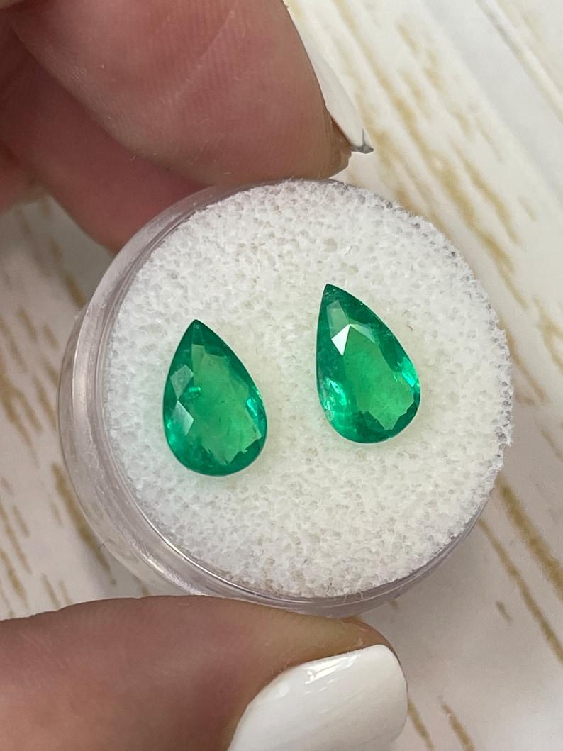 Stone: Emerald
Total Weight: 2.33-tcw
Shape: Pear Cut
Clarity: Transparent
Luster: Very Good
Color: Medium Green
Measurements: 10.83mm x 6.68mm x 4.20mm // 10.13mm x 6.74mm x 3.94mm
Geographic Origin: Colombia
Treatment: Natural, Oiling

No two
