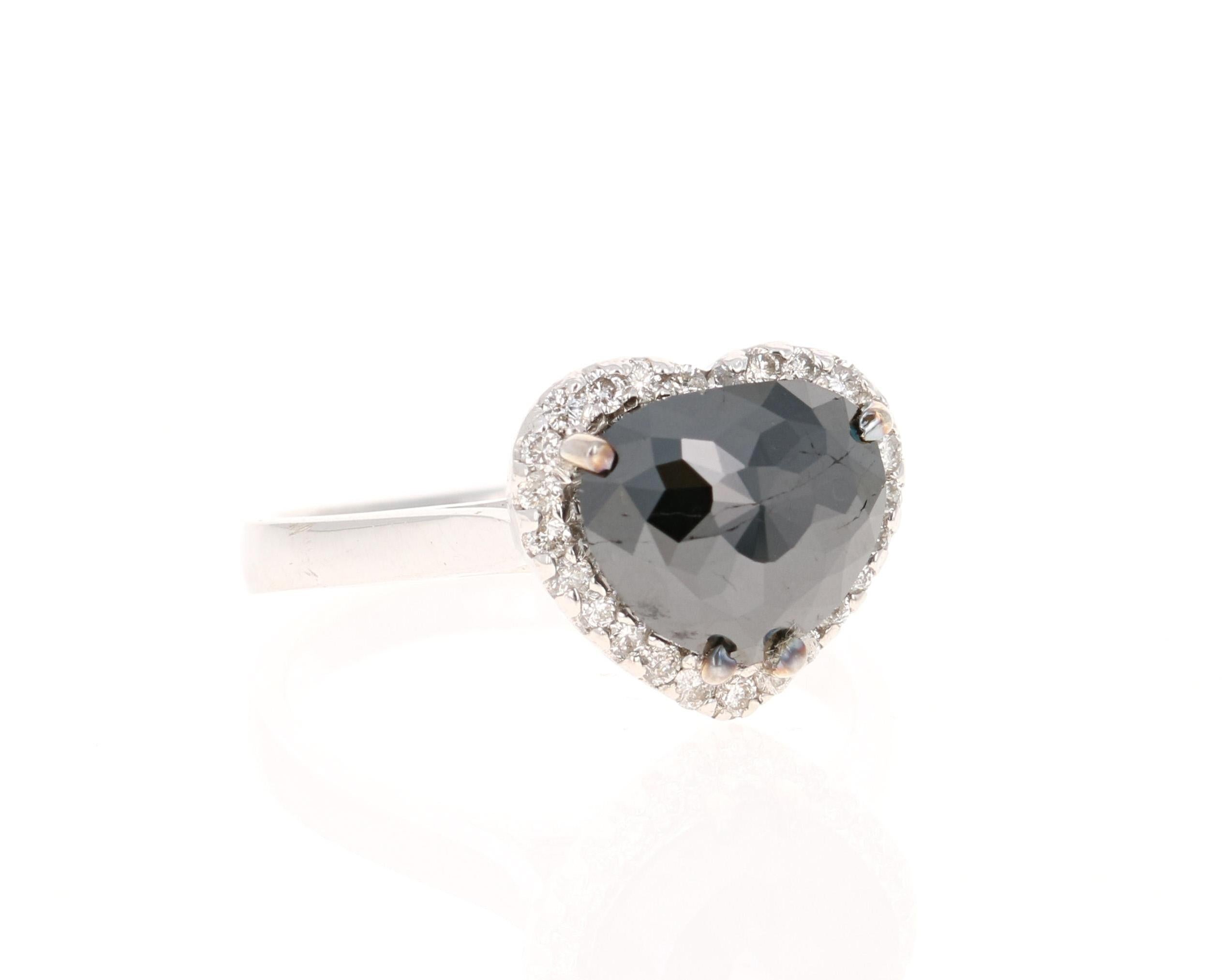 This heart cut Black Diamond weighs 2.07 carats and is surrounded by 25 Round Cut Diamonds that weigh 0.27 carats. The total carat weight of the ring is 2.34 carats. 

The Black Diamond are natural diamonds that have been color-treated to give them