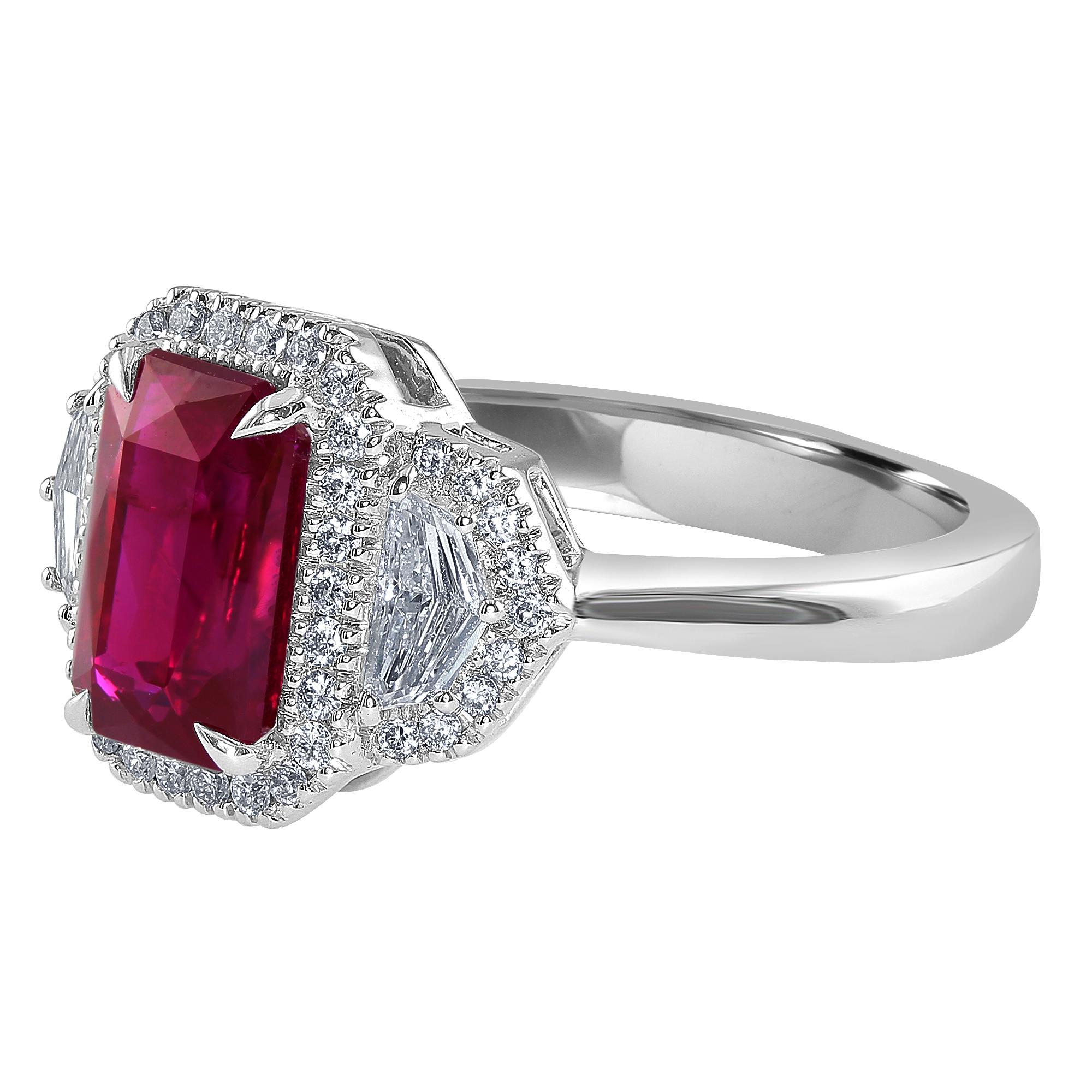 This ring features a 2.34 carat Emerald cut Ruby, set between two epaulet diamonds, 0.26 carat, total weight.

The ruby and epaulet diamonds are surrounded by a halo of round diamonds, 0.20 carat, total weight.

Absolutely stunning and vibrant red