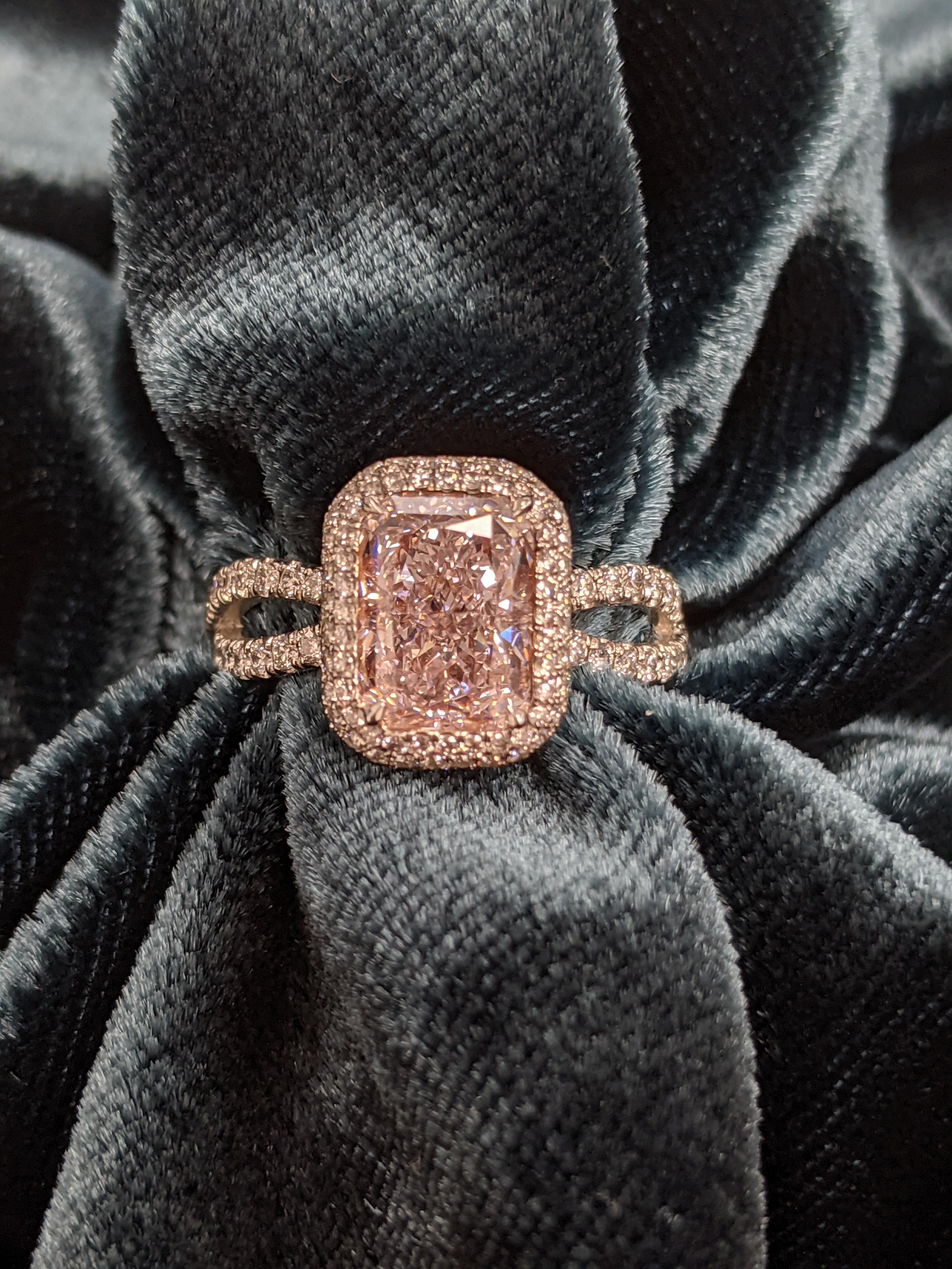 This lovely pink damond ring is extremely wearable and suitable for many occastions.  The center is a 2.34 carat Very light pink radiant cut and is Internally Flawless.  It is set in platinum and rose gold.    Our office runs 10 diamond cutting