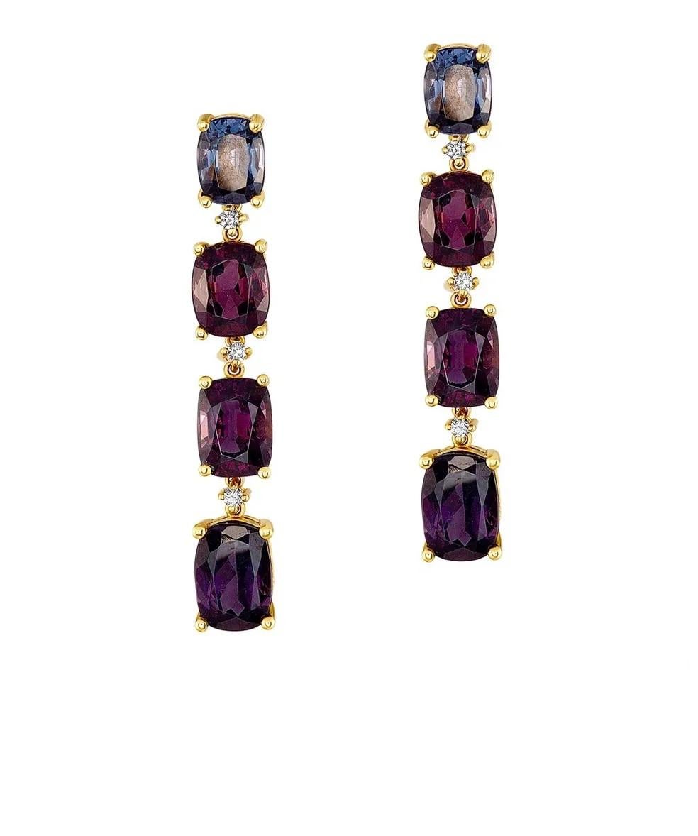 An elegant and sophisticated dangle earring featuring four untreated purple spinels per earring for a total carat weight of 23.43 carats with .17ctw of round diamonds spaced between each spinel. Set in 18 karat yellow gold with a post back and