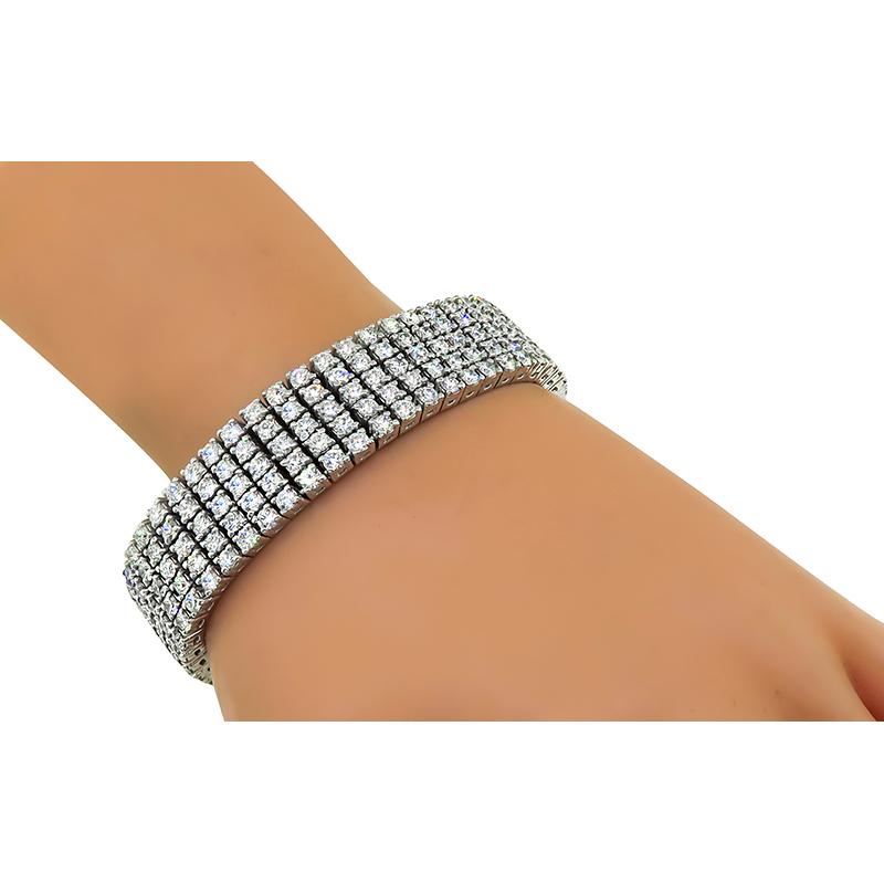 This is an amazing 14k white gold bracelet. The bracelet is set with sparkling round cut diamonds that weigh approximately 23.45ct. The color of the diamonds is G-H with VS clarity. The bracelet measures 16mm in width and 7 1/4 inches in length. The