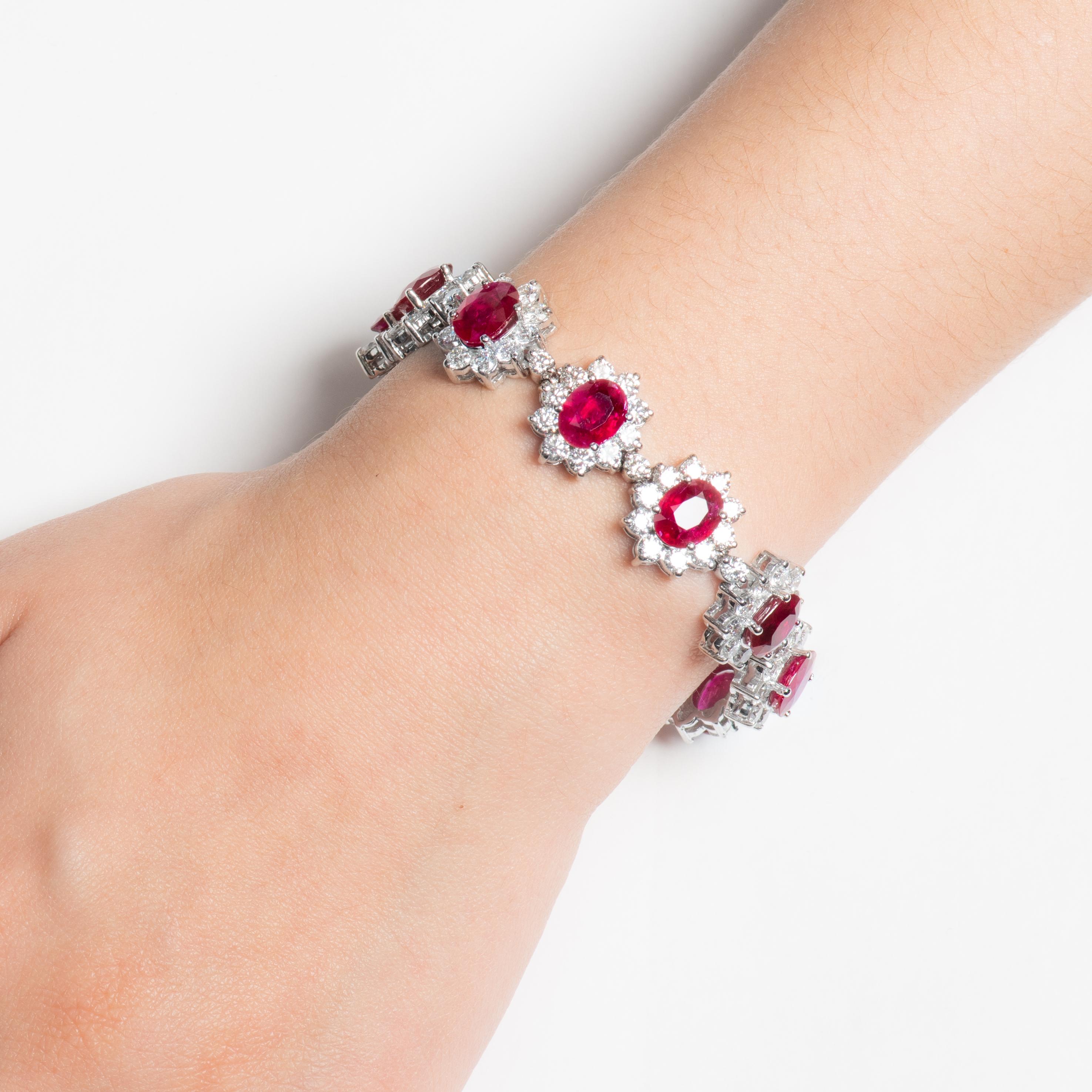 This exquisite bracelet features 11 fine, rich, intensely red oval rubies with a total weight of 23.45ct. The rubies have a medium saturation, and are very lively and bright, beautifully matched to each other. They are surrounded  by round diamond