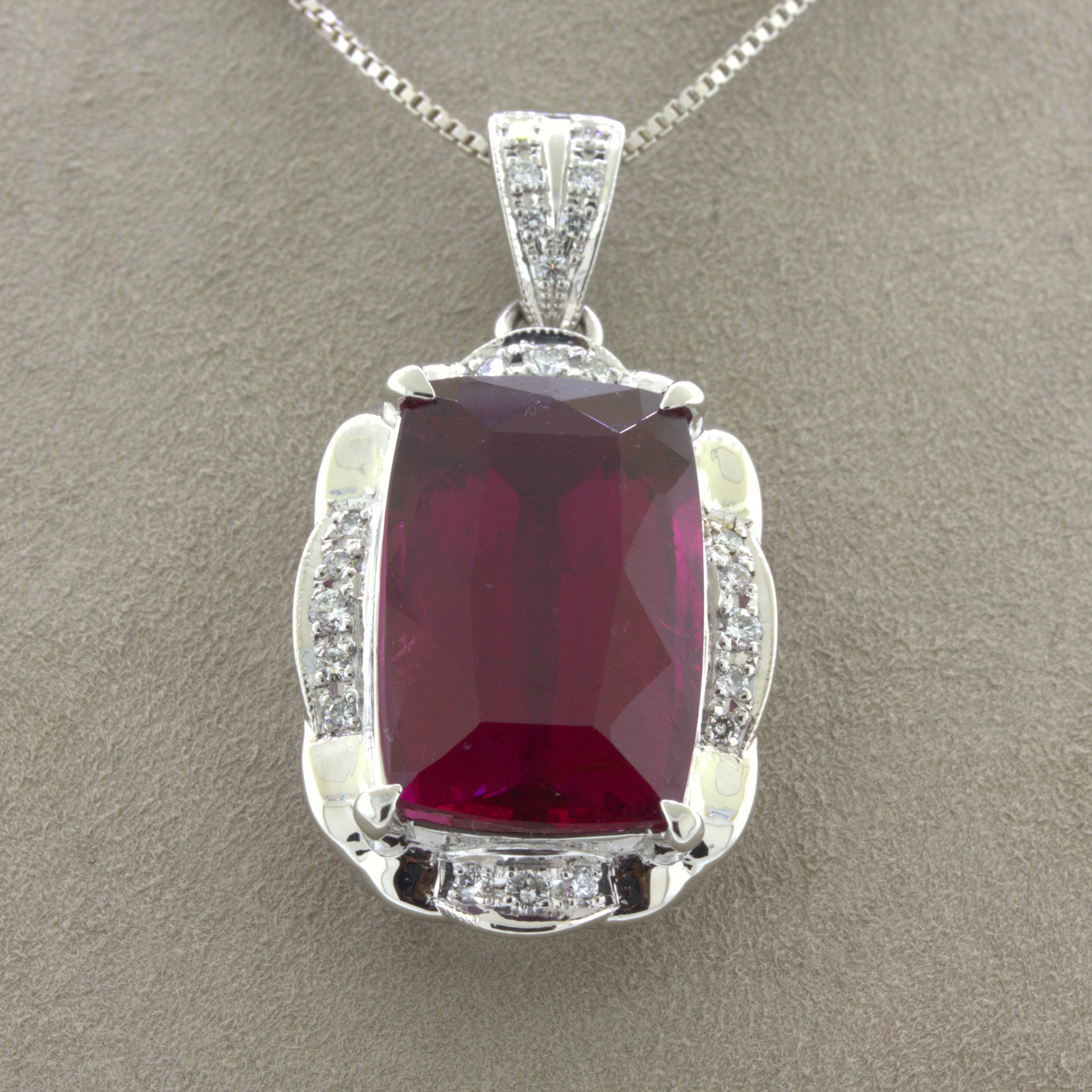 A very fine electric vivid red rubellite tourmaline takes center stage of this platinum pendant. It weighs an impressive 23.49 carats and has a super rich vivid color that will mesmerize anyone who looks into the stone. It is complemented by 0.39