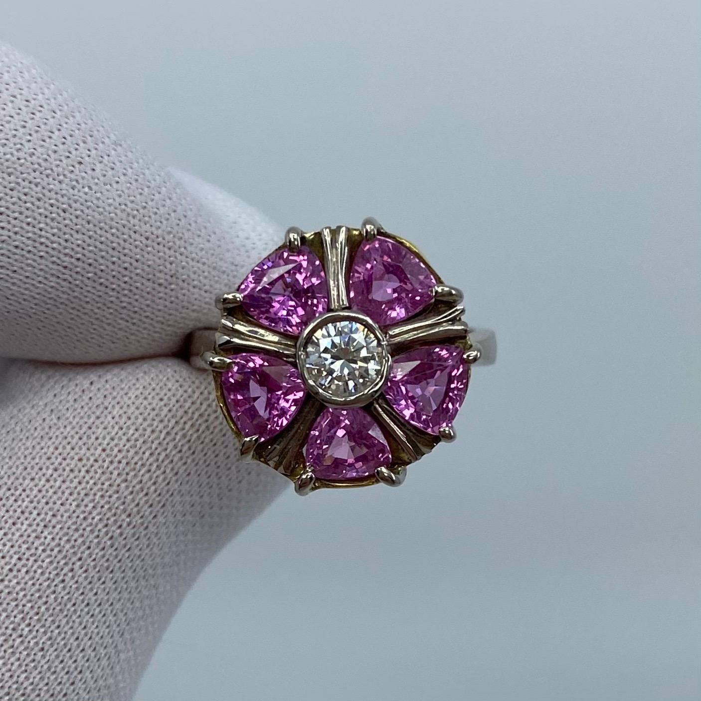 Vivid Pink Sapphire & Diamond 18 Karat White Gold Art Nouveau Style Ring.

A beautiful cocktail ring set with approx 2 carat of vivid pink sapphires and a 0.34ct centre diamond. 
All the sapphires have very good to excellent clarity with an