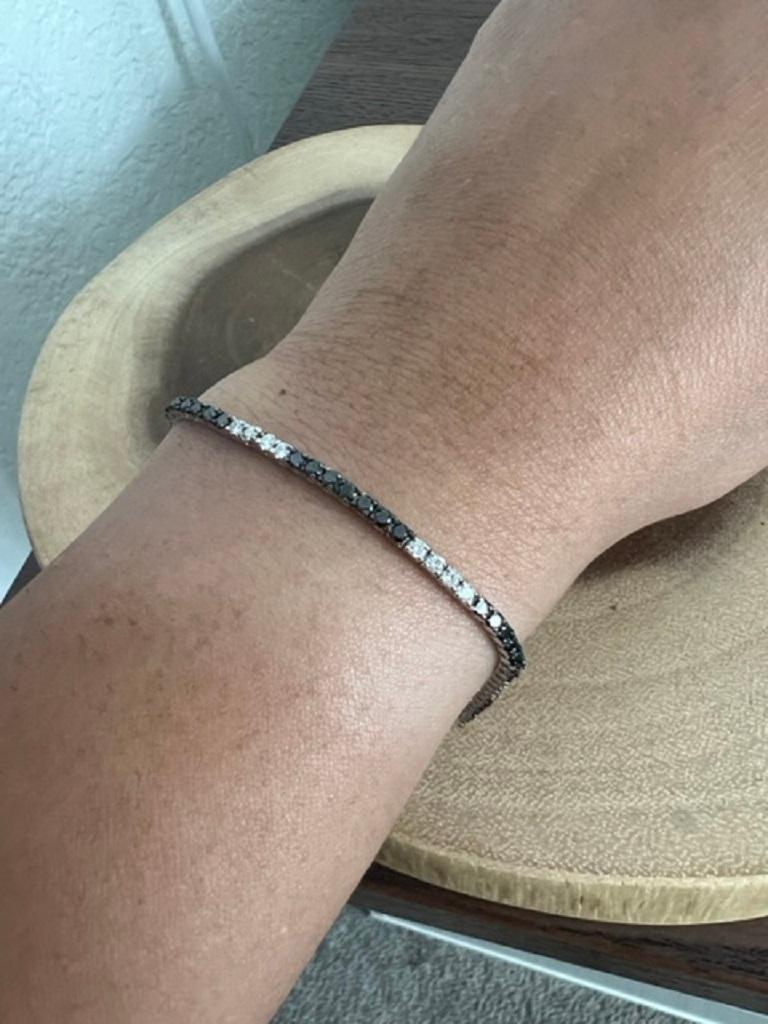This bracelet has Natural Round Cut Black Diamonds that weigh 1.56 carats and Natural Round Cut White Diamonds that weigh 0.79 carats, (Clarity: SI, Color: F) The total carat weight of the bracelet is 2.35 carats. 

It is set in 14 Karat White Gold