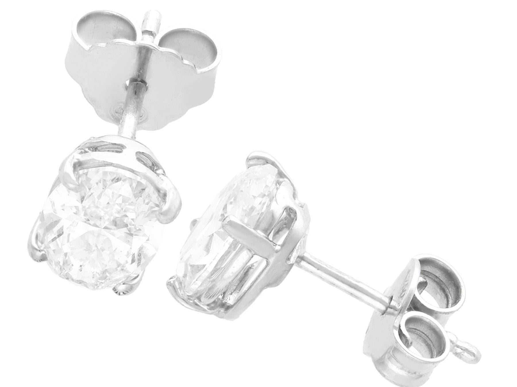 A fine and impressive pair of contemporary 2.35 carat diamond and 18 karat white gold stud earrings; part of our diverse diamond jewelry and estate jewelry collections.

These impressive 2.35 carat oval diamond stud earrings have been crafted in 18k