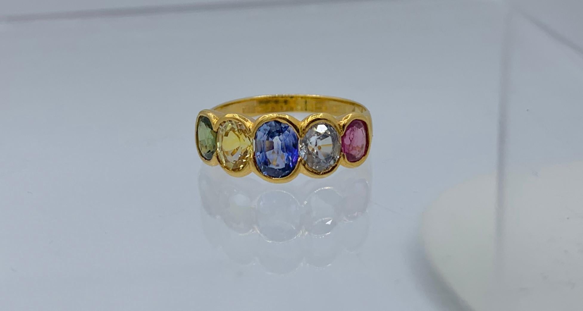 This is a stunning and very special antique Ring with five oval multicolored green, yellow, blue and pink Sapphires which total approximately 2.35 Carats.  The magnificent colored sapphires have five varied shades and hues and are extremely lively