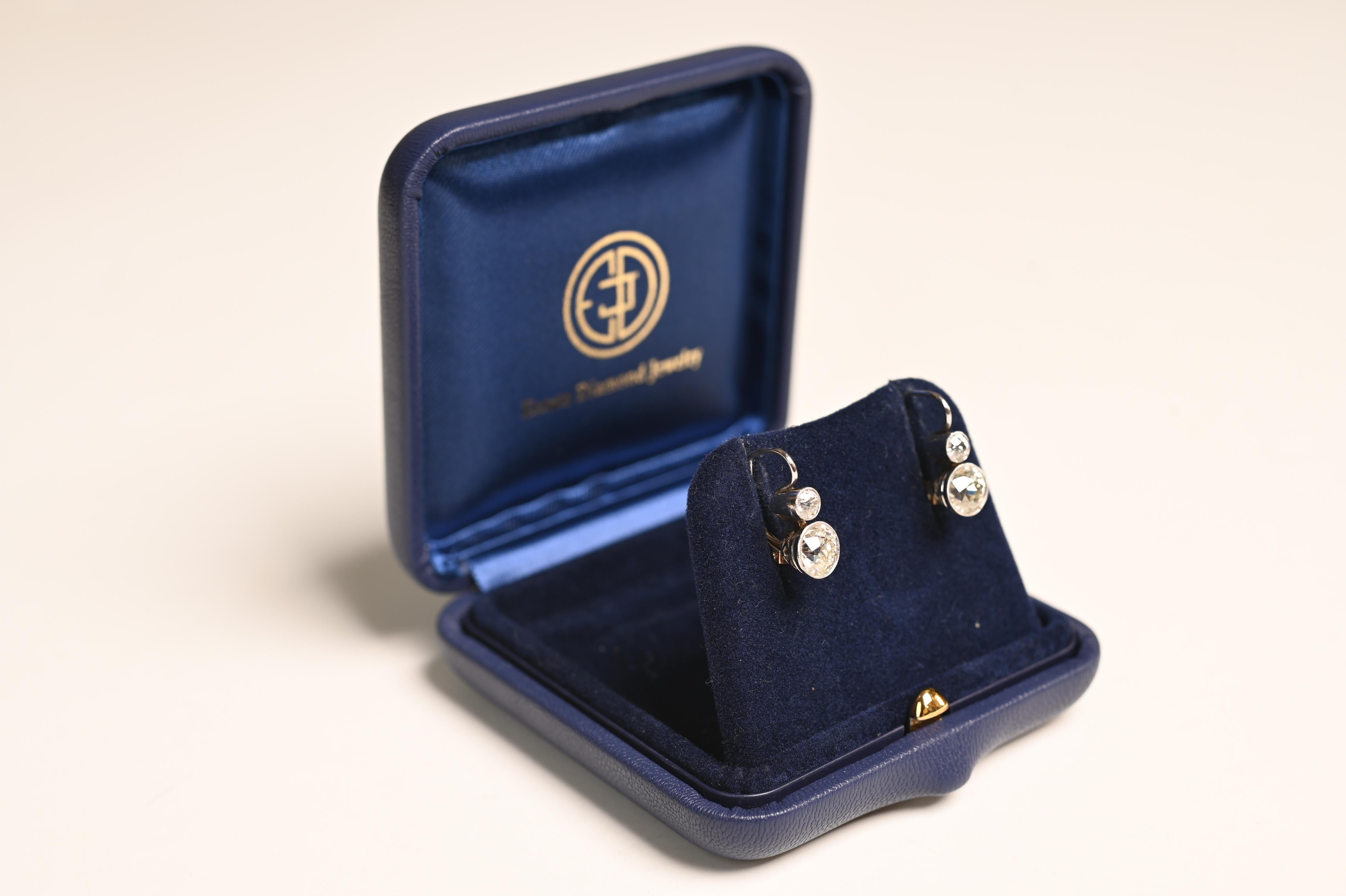 This exquisite pair of earrings showcases a stunning combination of old European cut diamonds, masterfully set in platinum and 18k yellow gold. The two bottom diamonds, with a combined weight of approx 2.30-carats, offer a brilliant and timeless
