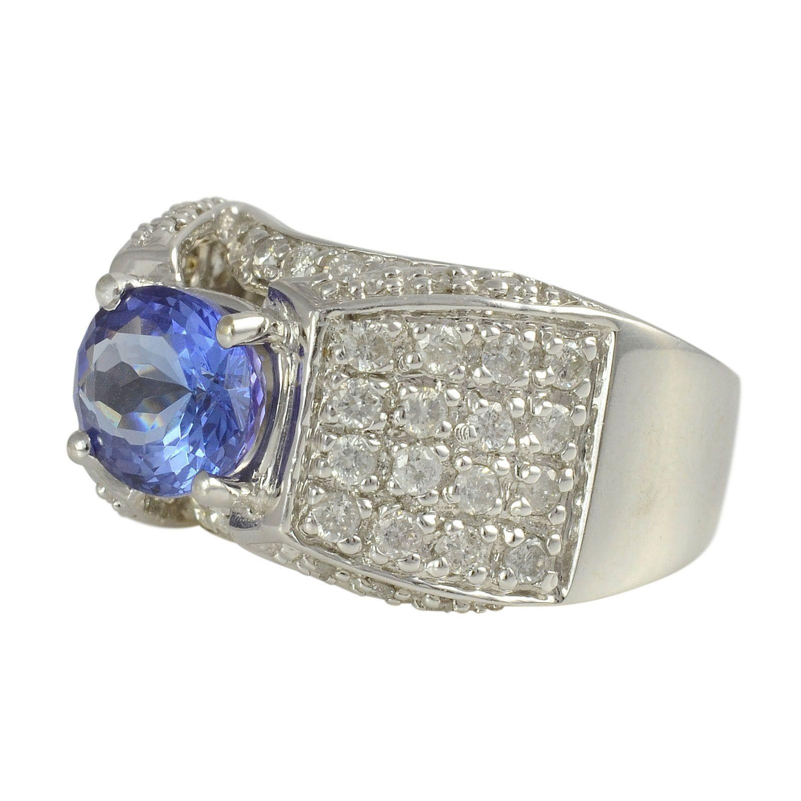 Estate 2.35 carat tanzanite ring with diamonds. The ring is set in 14 karat white gold with a 2.35 carat oval tanzanite and 54 diamonds at 1.10 carat total weight SI1-2 clarity I-J color, marked RRJ. Size 6.25. Appraised at $4,300. [SJ SAUC3094 P]