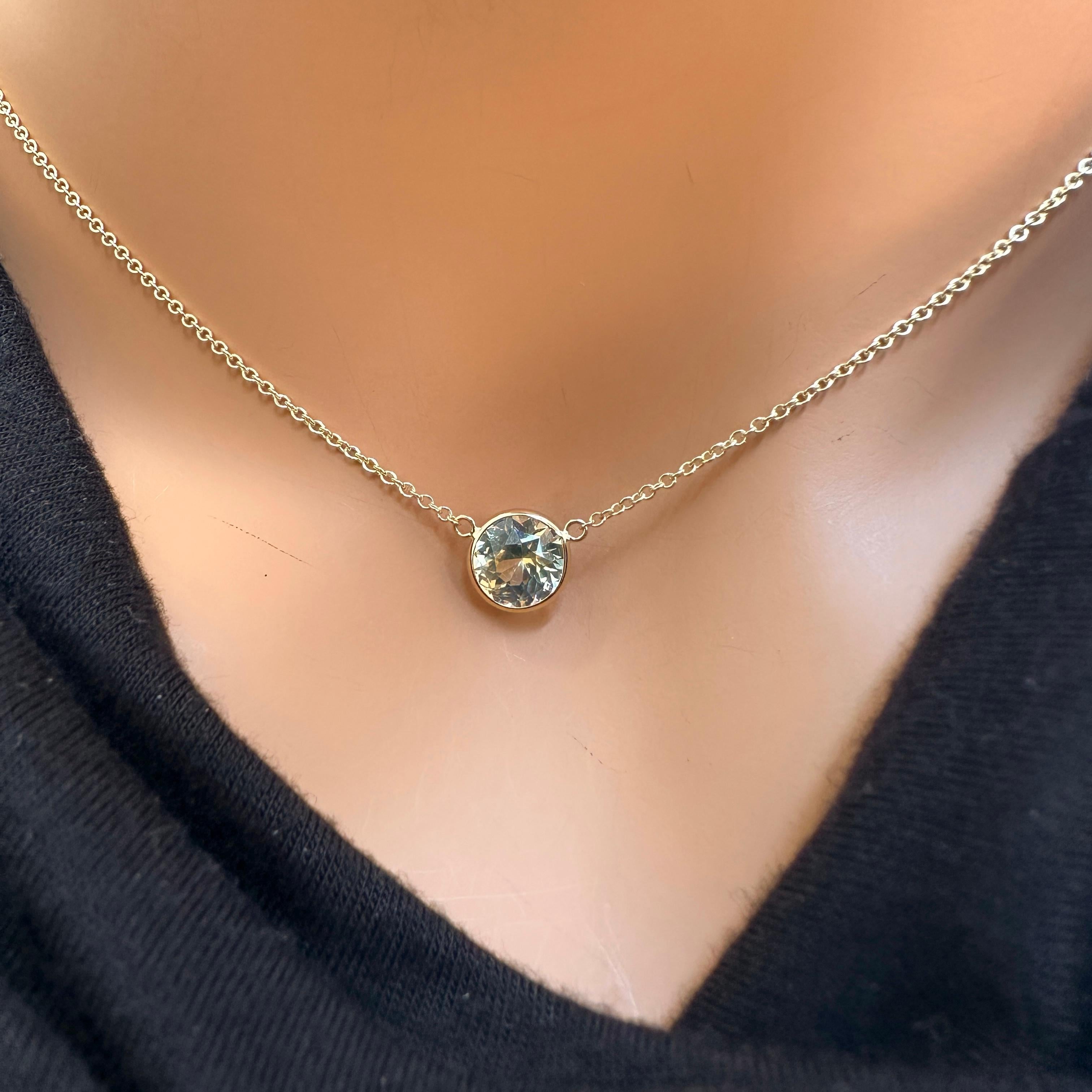 A fashion necklace made of 14k yellow gold with a main stone of a certified round yellow sapphire weighing 2.35 carats would be a stunning choice. Yellow sapphires are known for their vibrant yellow color and durability, making them an excellent