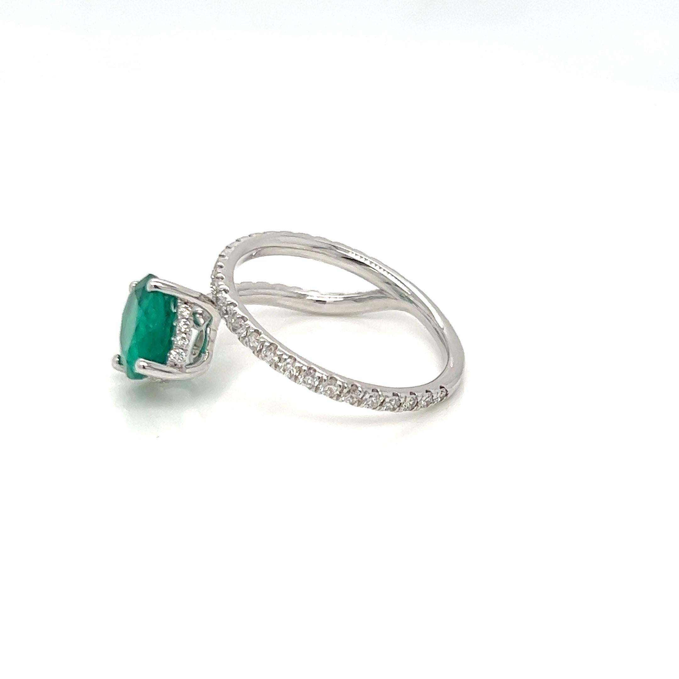 This modernistic ring features a 9x7 oval cut emerald weighing 1.70 carats along with round brilliant cut diamonds weighing 0.65 carats. This ring gives an expensive look but yet trendy feels. The emerald used are from Zambia known for its