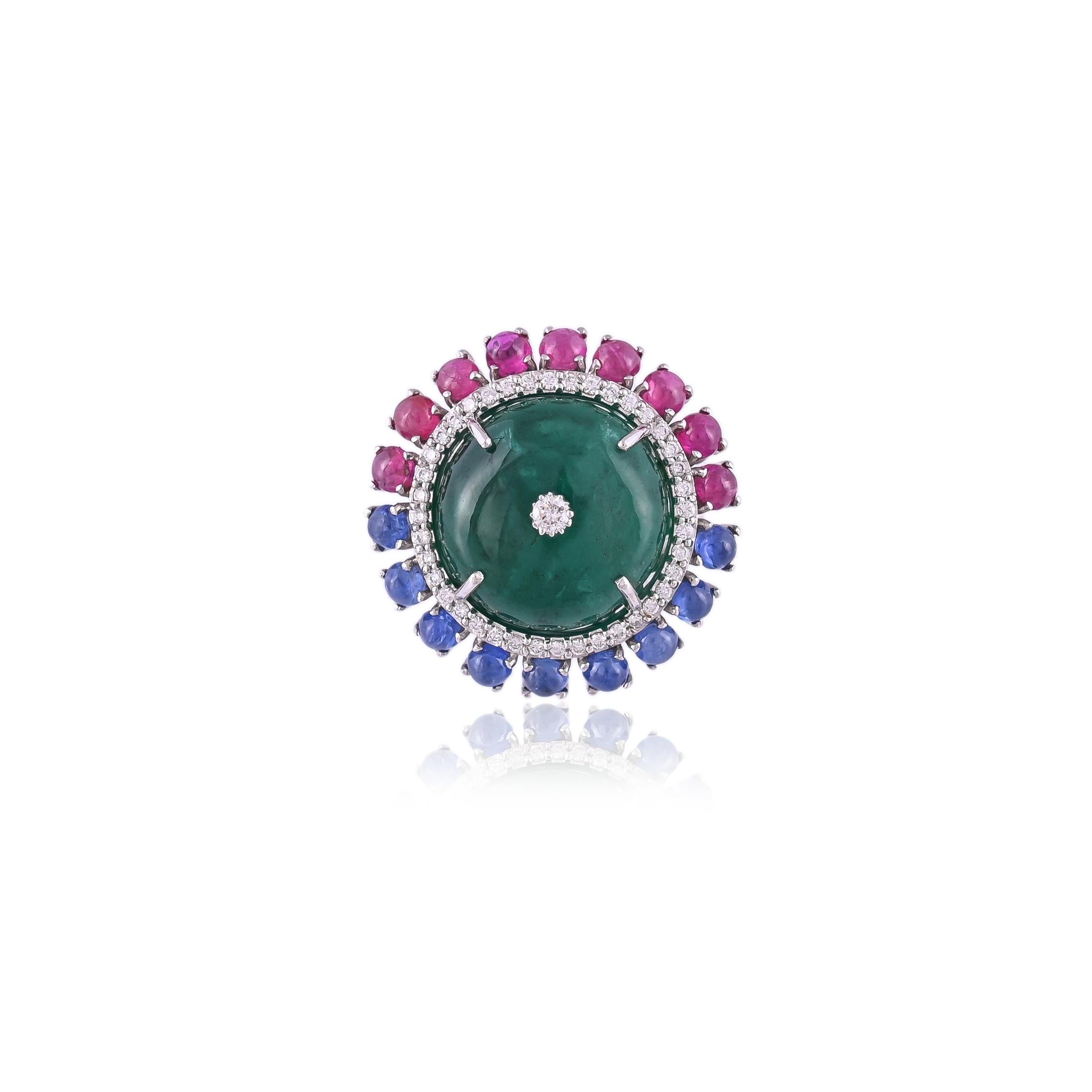 A very beautiful and one of a kind, Emerald, Blue Sapphire, Ruby Cocktail Ring set in 18K Gold & Diamonds. The Emerald is of Zambian origin, completely natural without any treatment and weighs 23.58 carats. The Blue Sapphire is of Burmese origin,