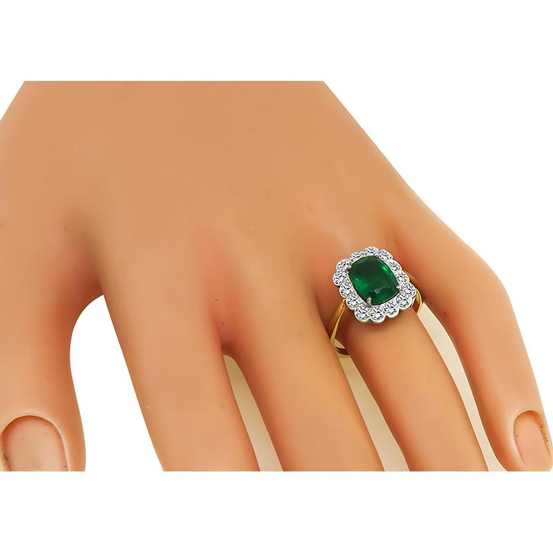 This is an amazing 14k gold engagement ring. The ring is centered with a lovely cushion cut emerald that weighs approximately 2.35ct. The emerald is accentuated by sparkling round cut diamonds that weigh approximately 0.70ct. The color of these