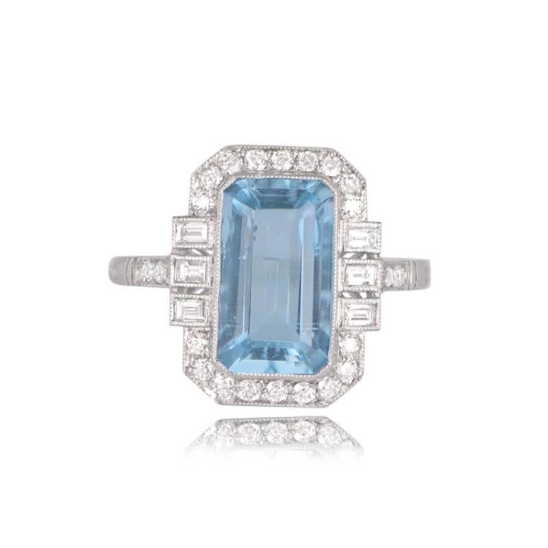 A captivating geometric ring showcasing a vibrant emerald cut natural aquamarine weighing around 2.35 carats, displaying a striking teal saturation. The center stone is encircled by old European cut diamonds, while each side is adorned with three