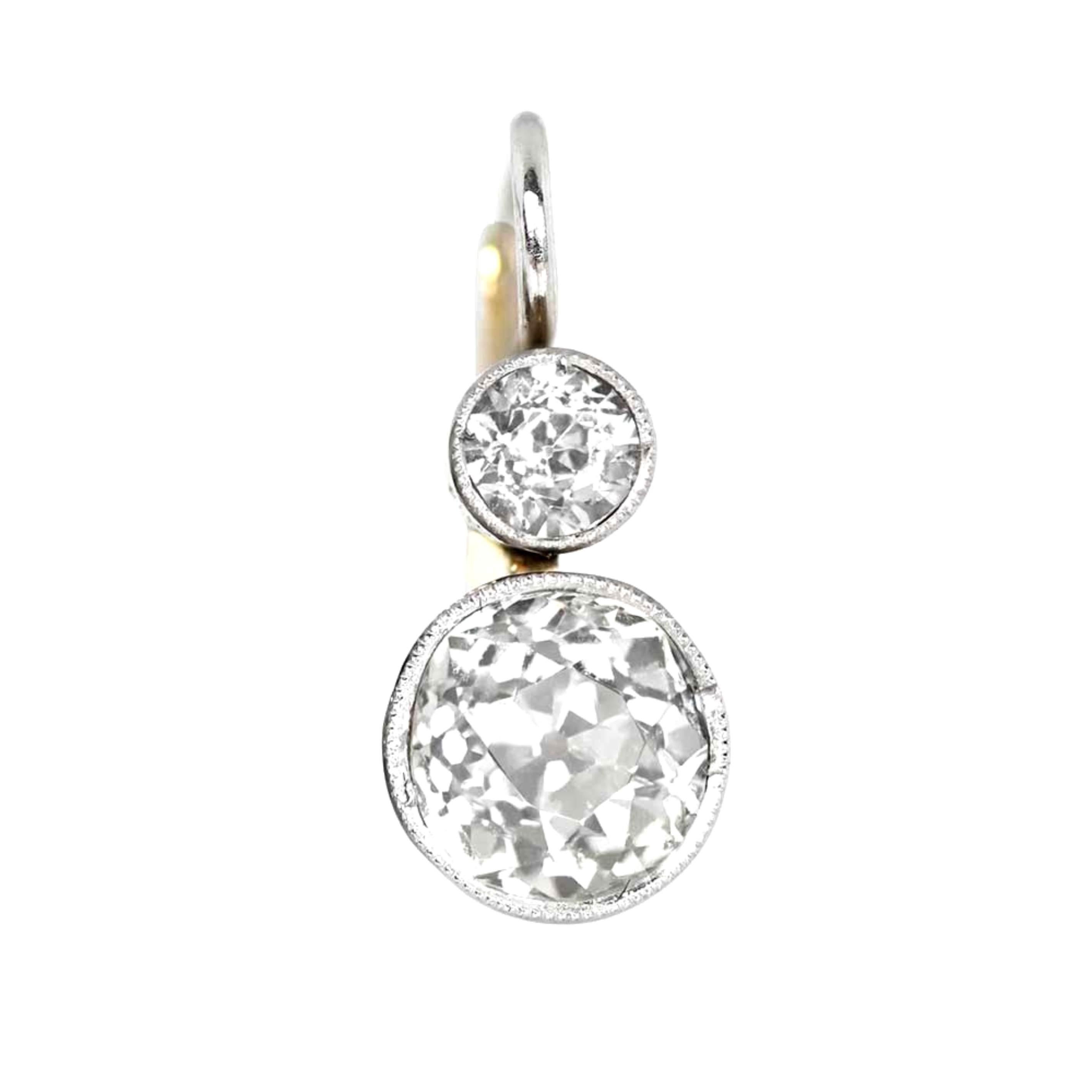 Experience the irresistible charm of these stunning 2.35-carat Old European cut diamond earrings, flawlessly showcased in a luxurious platinum setting on 18k yellow gold. The larger diamonds, with a combined weight of 2.35 carats, are complemented