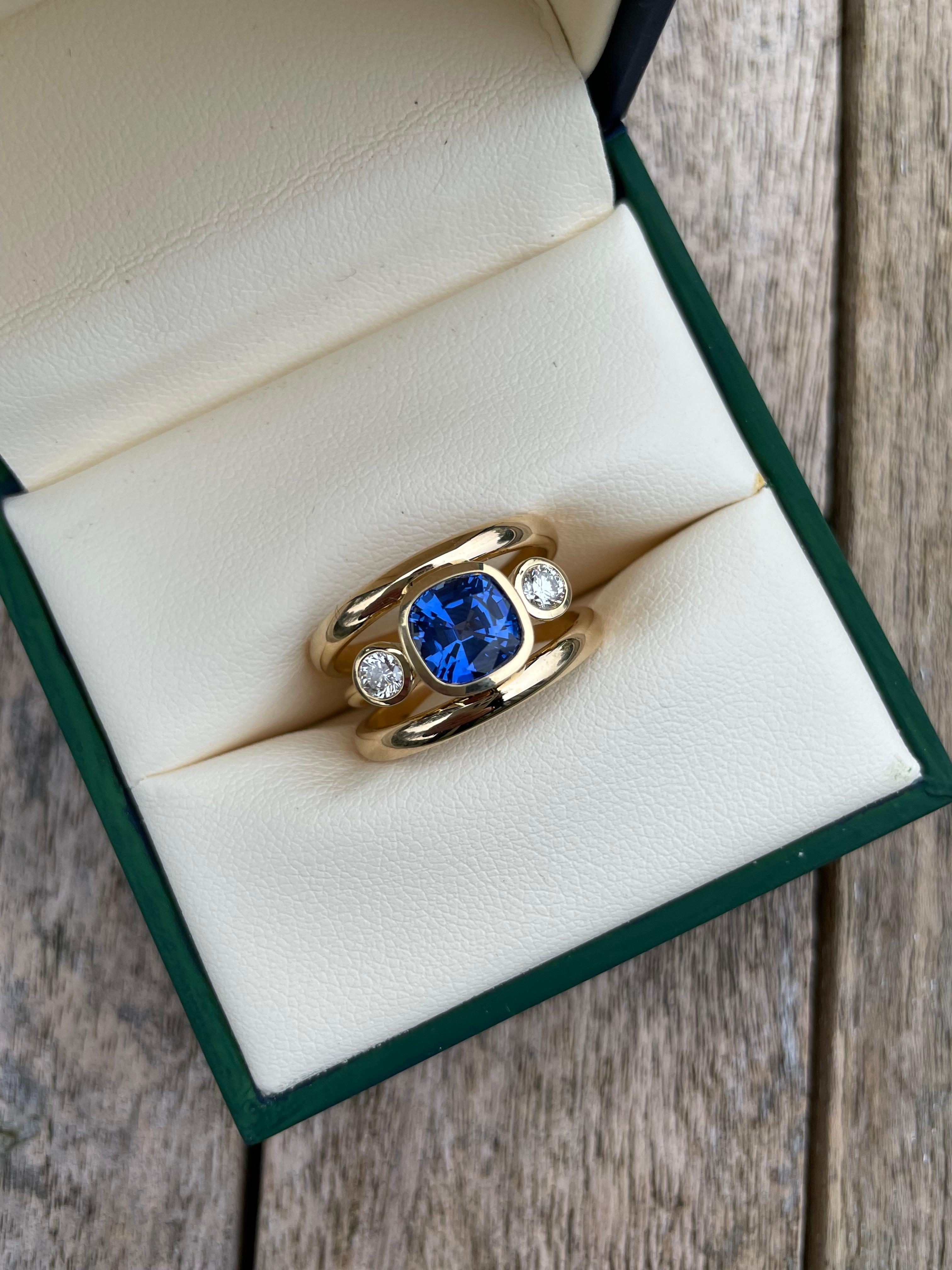  Minka Jewels - This beautiful and elegant 3 band ring set with the most incredible 2.35ct Sri Lankan, Royal Blue Sapphire.
This exceptional sapphire is set with a diamond on either side and in 18k yellow gold. Hand made in Londons historic