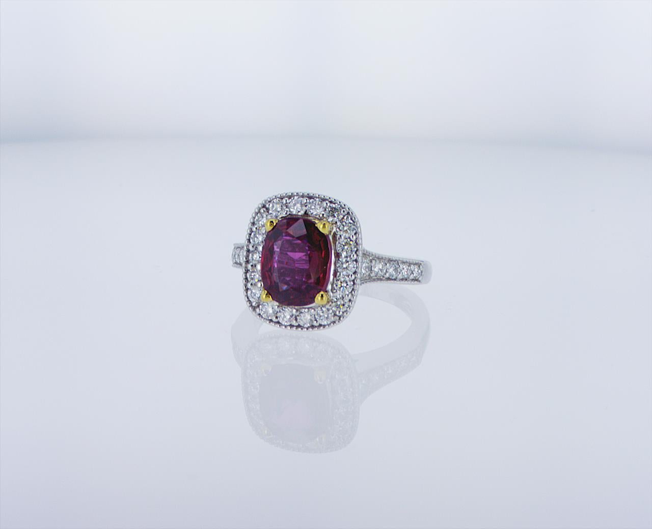 2.35ct Ruby Cocktail Ring featuring 0.82ct Total Weight of G/H Color VS Clarity Round Brilliant Diamonds in an 18k White Gold with Palladium Mounting with 18k Yellow Gold Center Prongs.
