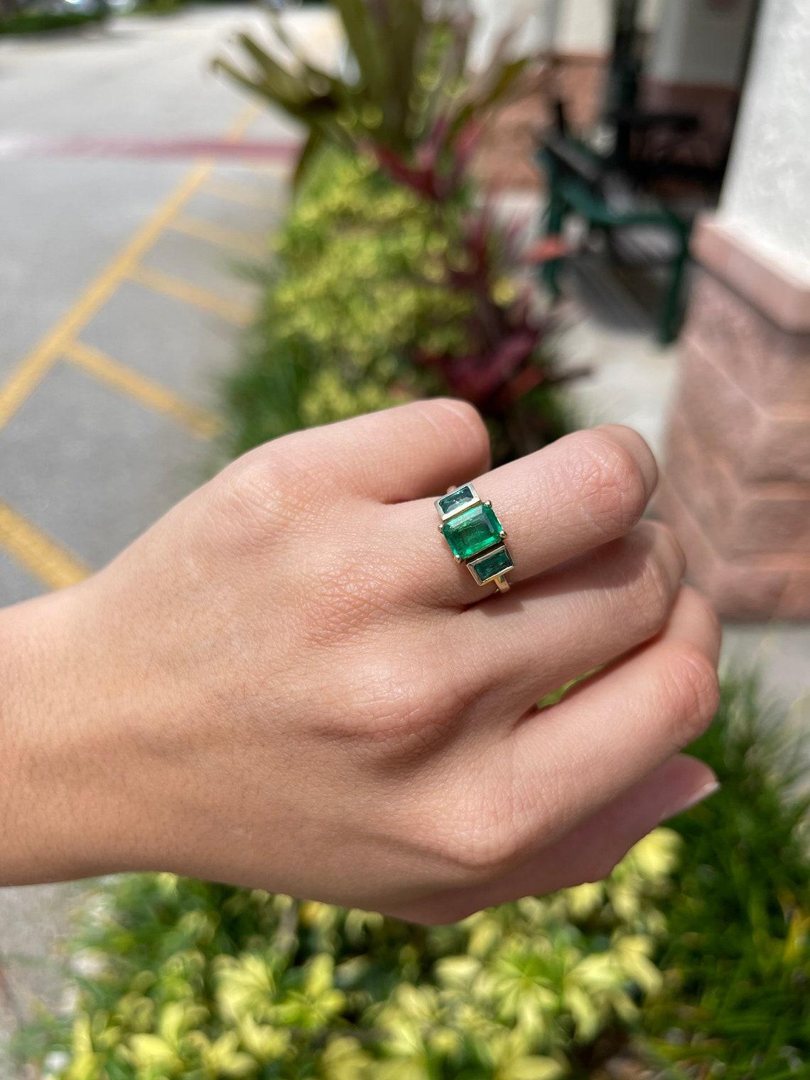 three stone emerald cut ring