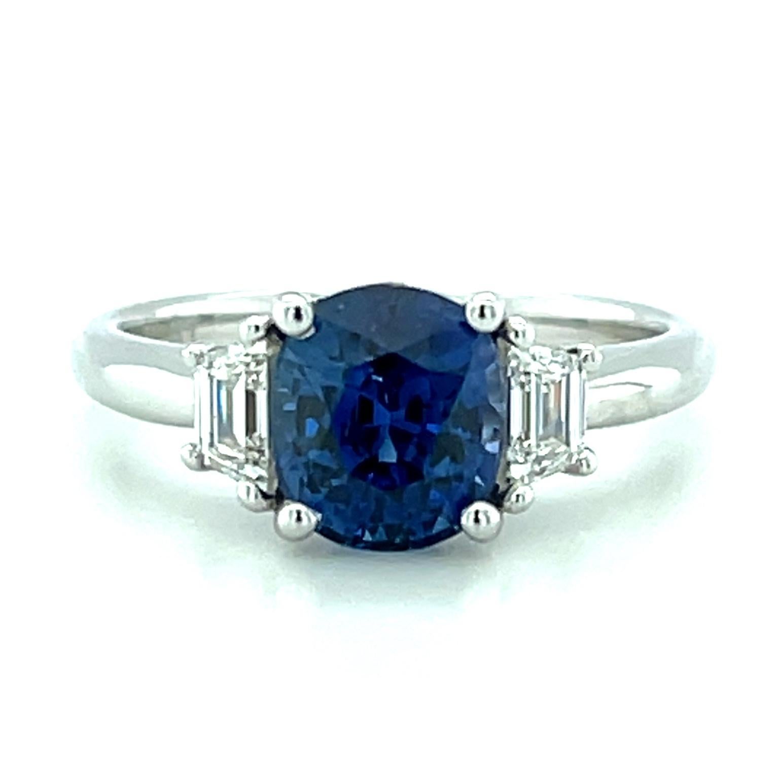 This beautiful 3-stone engagement ring features a sparkling, cushion-shaped Ceylon blue sapphire weighing 2.36 carats! The sapphire has gorgeous medium-blue color and corresponding GIA report #2225082226 certifying its Sri Lankan origin. Sri Lanka