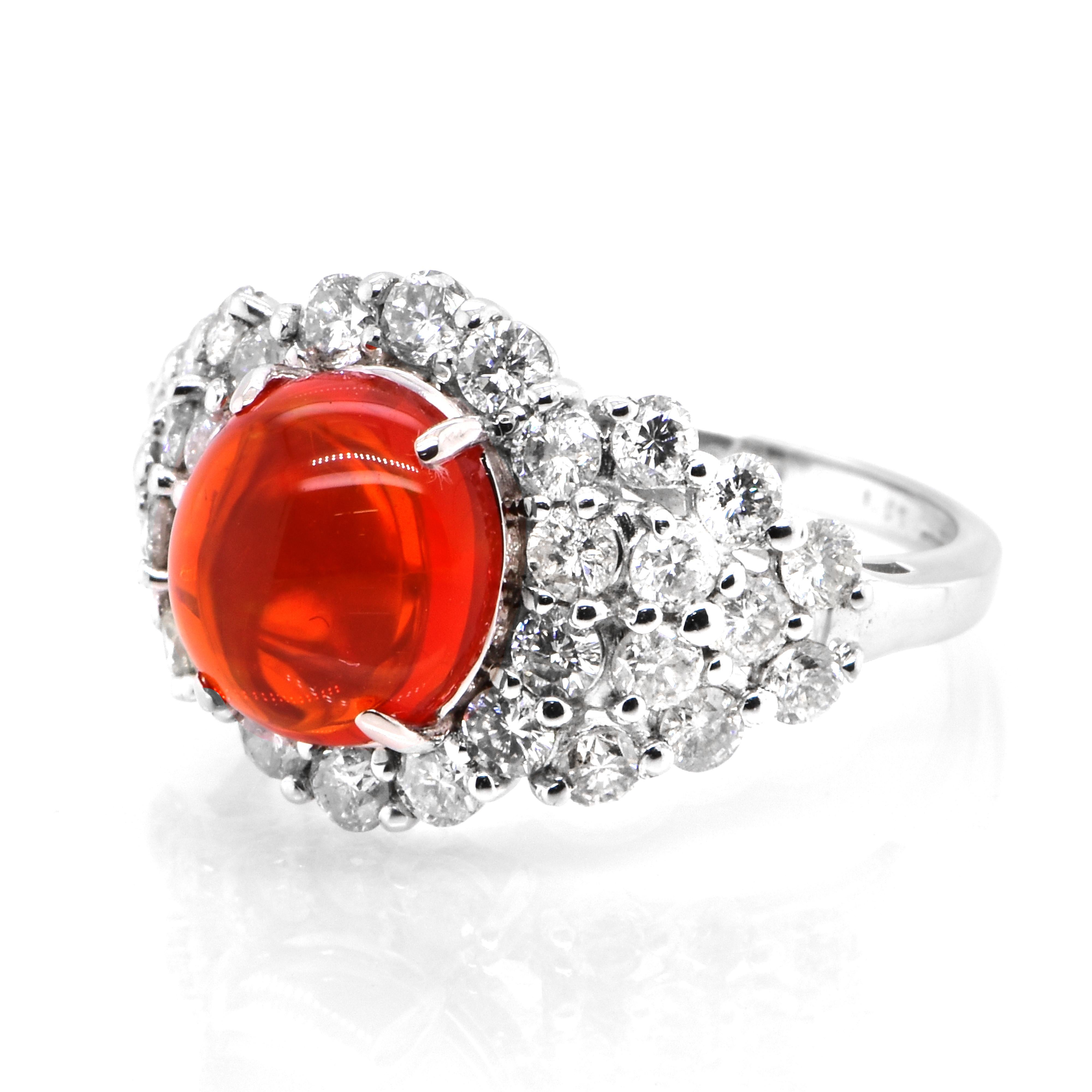 A beautiful ring featuring a 2.36 Carat Natural Mexican Fire Opal and 1.67 Carats of Diamond Accents set in Platinum. Opals are known for exhibiting flashes of rainbow colors known as 