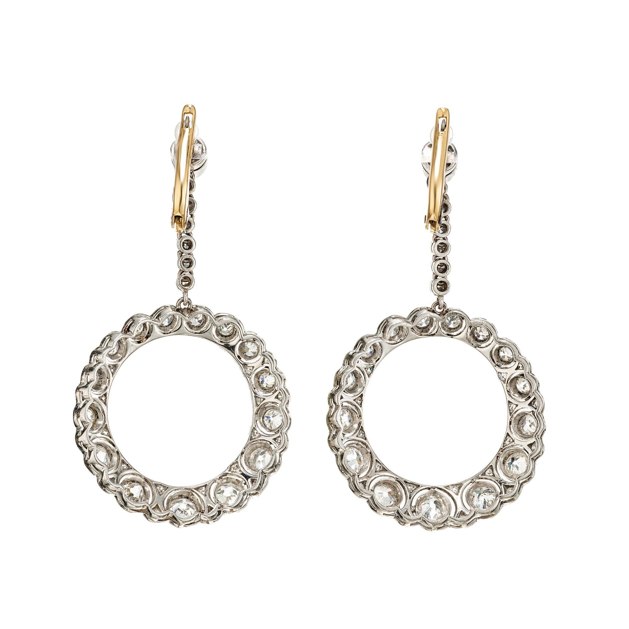 Adorn yourself with timeless elegance through our 2.36ct tound diamond platinum circle dangle Art Deco earrings. Each pair is a masterpiece, echoing the opulence of a bygone era with modern sophistication. Set in luxurious platinum and mounted with