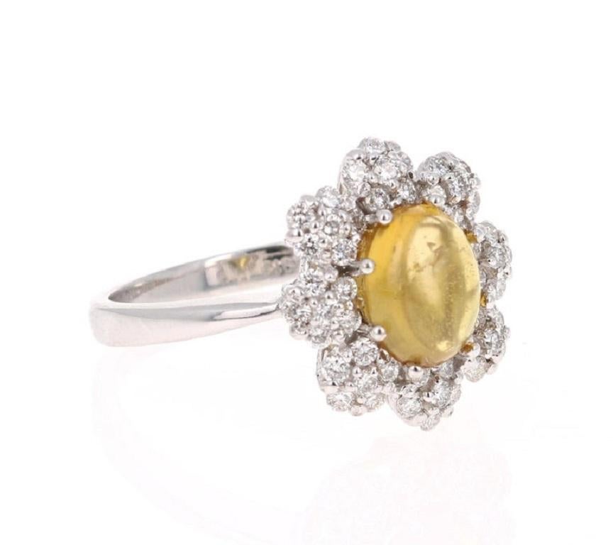 This ring has a pretty Oval Cut Yellow Tourmaline that weighs 1.74 Carats. Floating around the tourmaline is 48 Round Cut Diamonds that weigh 0.62 Carats. The total carat weight of the ring is 2.36 Carats. 

This beauty is set in 14 Karat White Gold