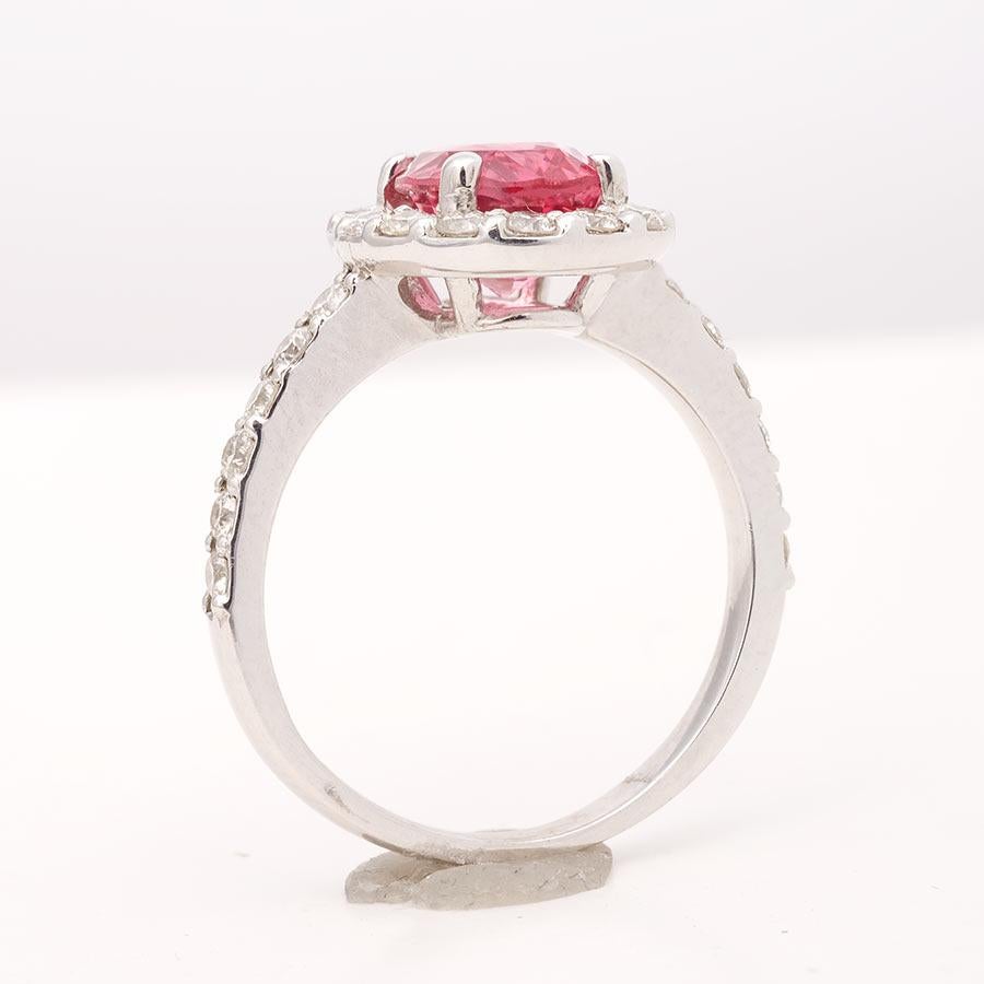 Neon pink mined in Tanzania, this Spinel cannot be matched. Its elegant color can flatter any skin tone. Forged in 14K white gold, with perfectly matched prong set diamonds the rings instantly gets a cool aura around the warm hues of the center