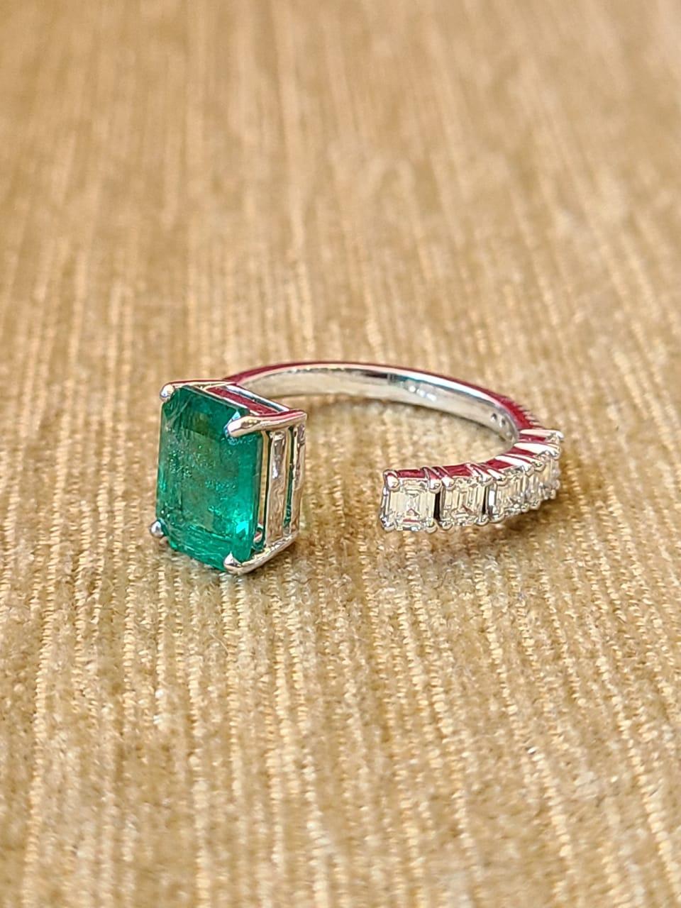A very gorgeous and dainty Emerald Engagement/ Cocktail Ring set in 18K Gold & Diamonds. The weight of the Emerald is 2.36 carats. The Emerald is of Zambian origin, and is completely natural, without any treatment. The combined weight of the