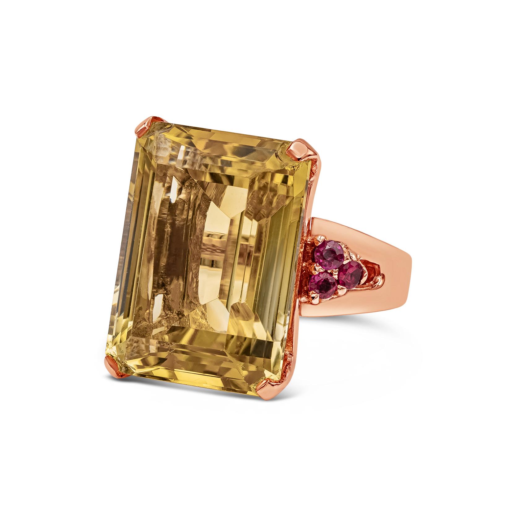 Showcasing an elegant and beautiful cocktail ring set with wonderful 23.62 carats emerald cut golden citrine, set in a classic four prong setting. Encrusted with brilliant ruby on each side weighing 0.30 carats total. Perfectly made in 14k rose