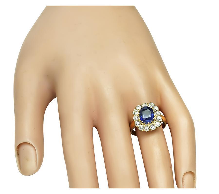 This is a magnificent 18k white gold ring. The ring is centered with lovely oval cut sapphire that weighs approximately 2.36ct. The sapphire is accentuated by sparkling old mine cut diamonds that weigh approximately 1.30ct. The color of these