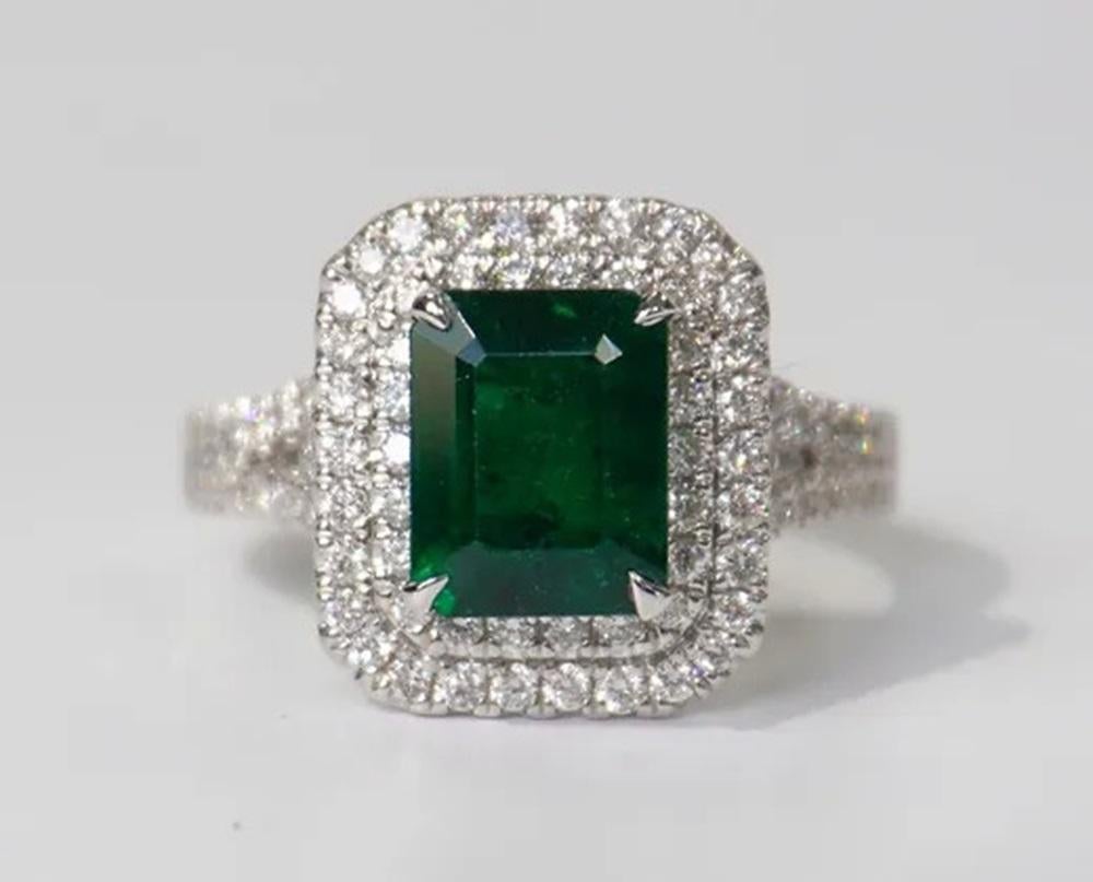 Emerald Weight: 2.37 ct, Measurements: 9x7.15 mm, Diamond Weight: 0.87 ct, Metal: 18K White Gold, Metal Weight: 6.17 gm, Ring Size: 6.5, Shape: Emerald-Cut, Color: Vivid Green, Hardness: 7.5-8, Birthstone: May, Origin: Zambia